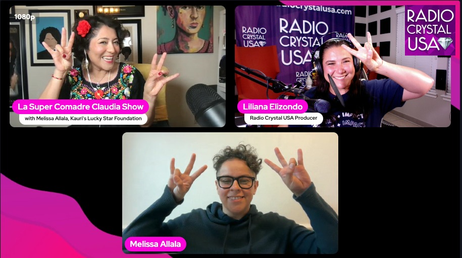 Three women smiling and making peace signs during a radio show interview.