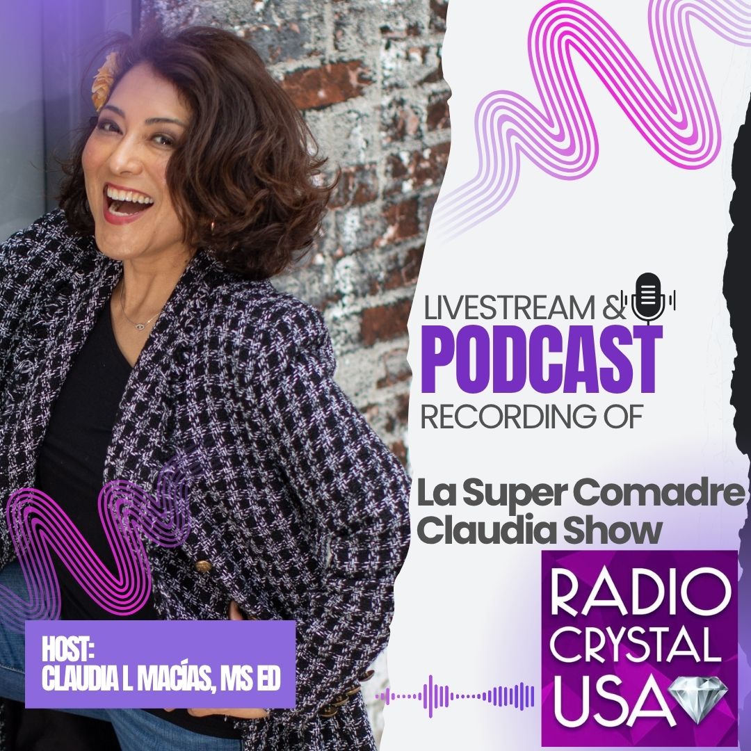 Woman with curly hair smiling, wearing a patterned blazer, standing in front of a brick wall and a podcast poster.