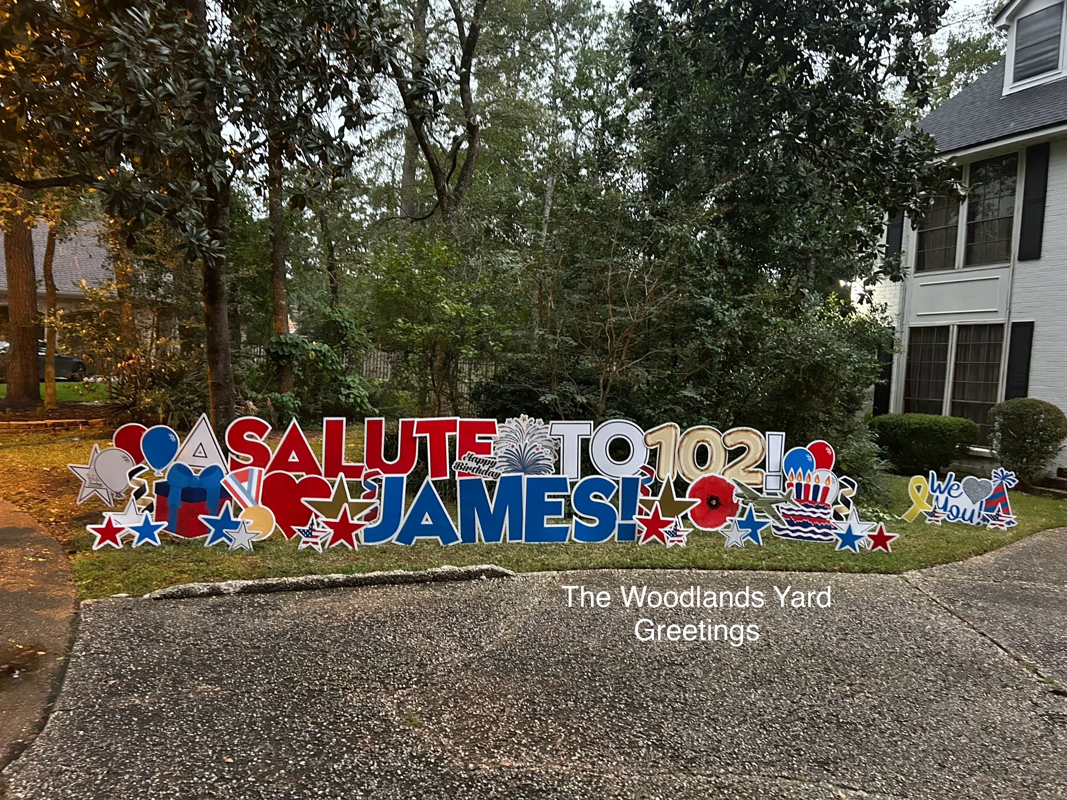 Decorative sign with patriotic colors and symbols, reading