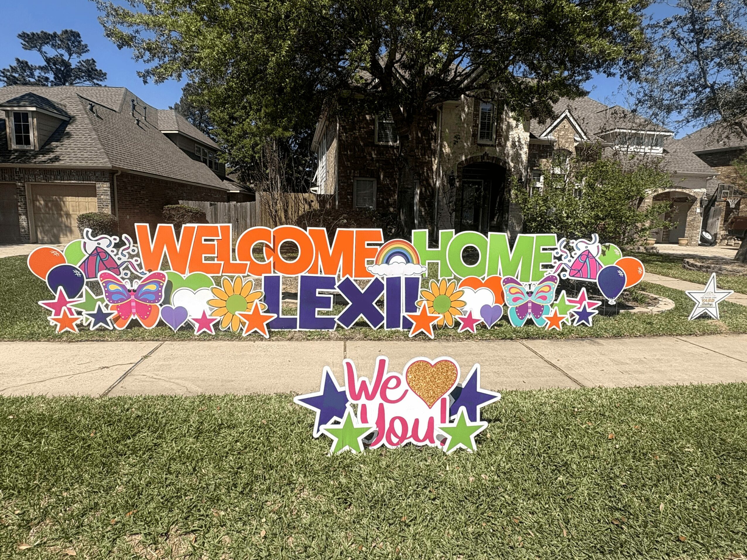 Colorful welcome sign with flowers and stars, reading
