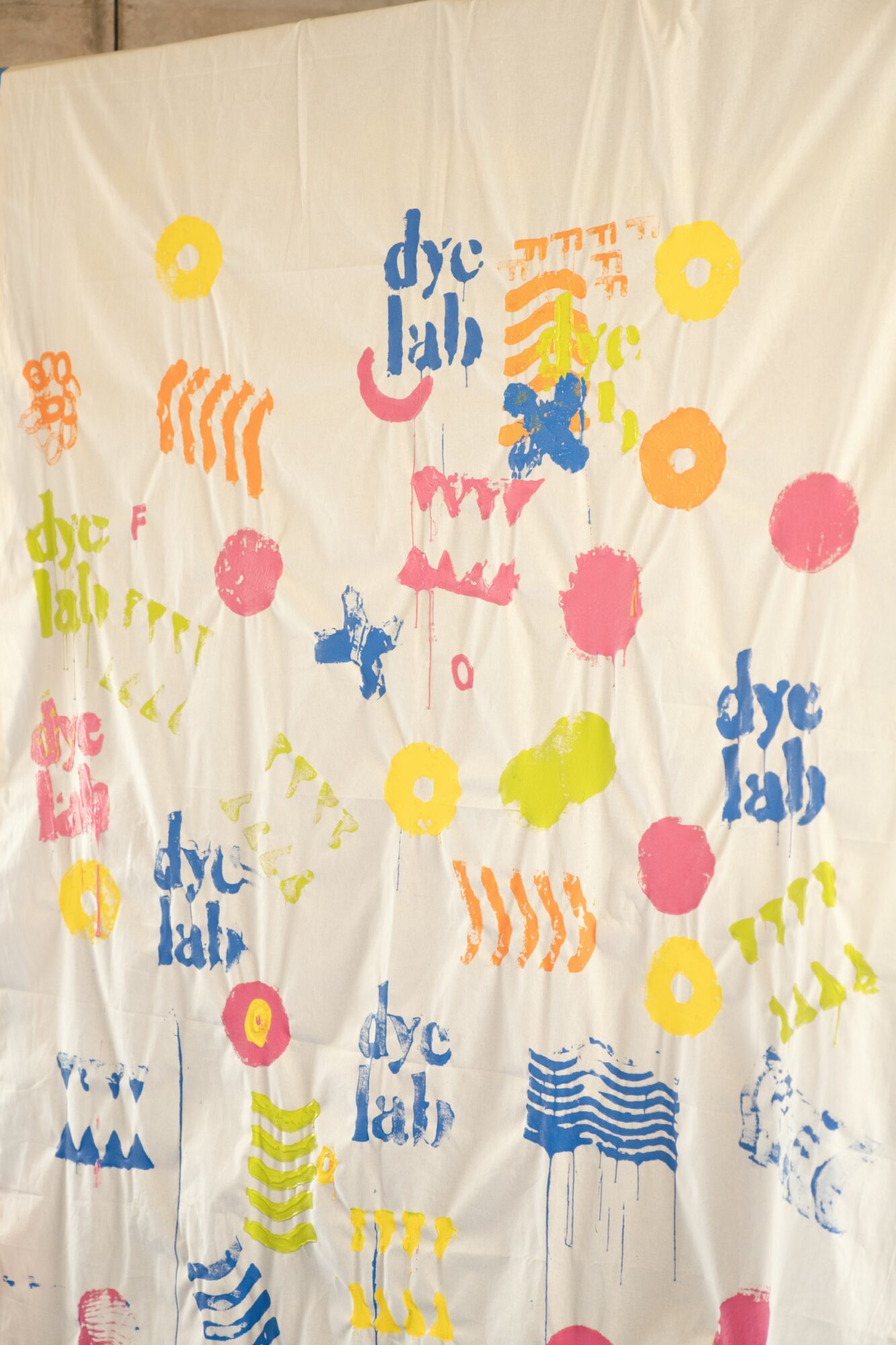 Colorful abstract shapes and text on a white background, with some shapes resembling flowers and waves.