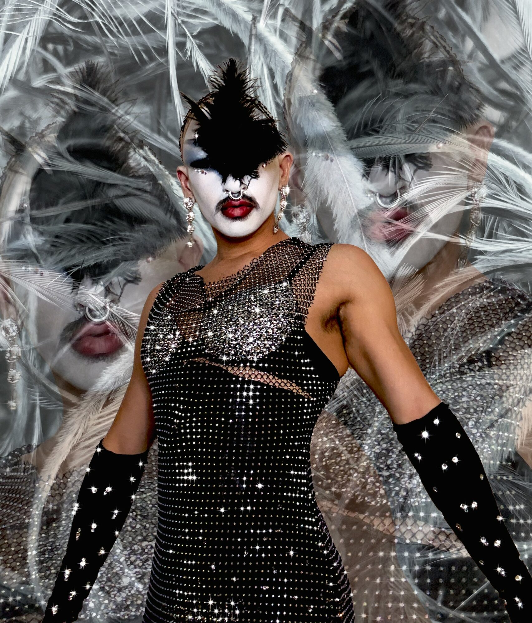 Person in elaborate costume with face makeup, black feathered headpiece, and long gloves, standing against a patterned background.