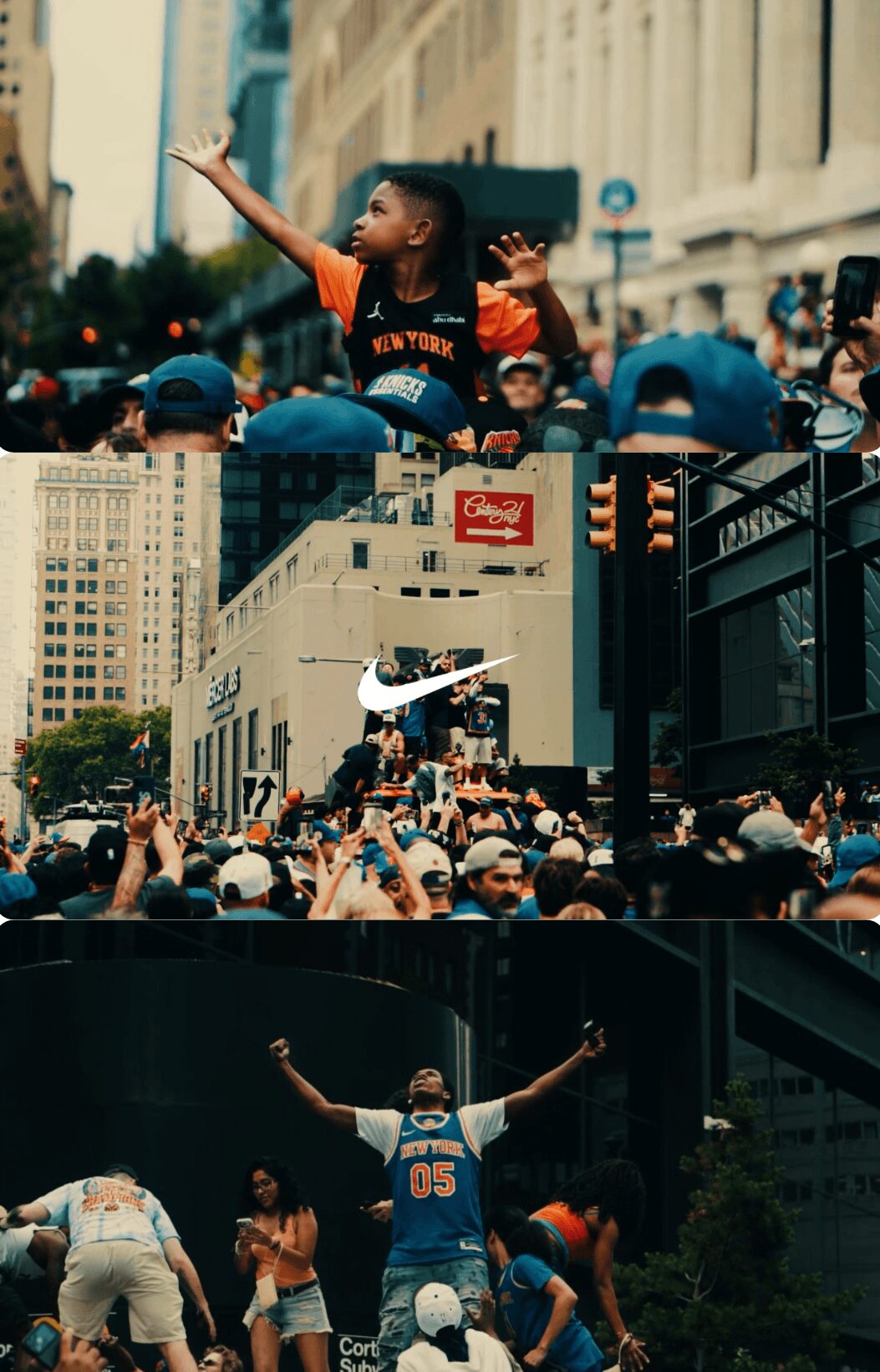 A person speaking to a crowd during a protest or rally in an urban setting, with buildings and signs visible.