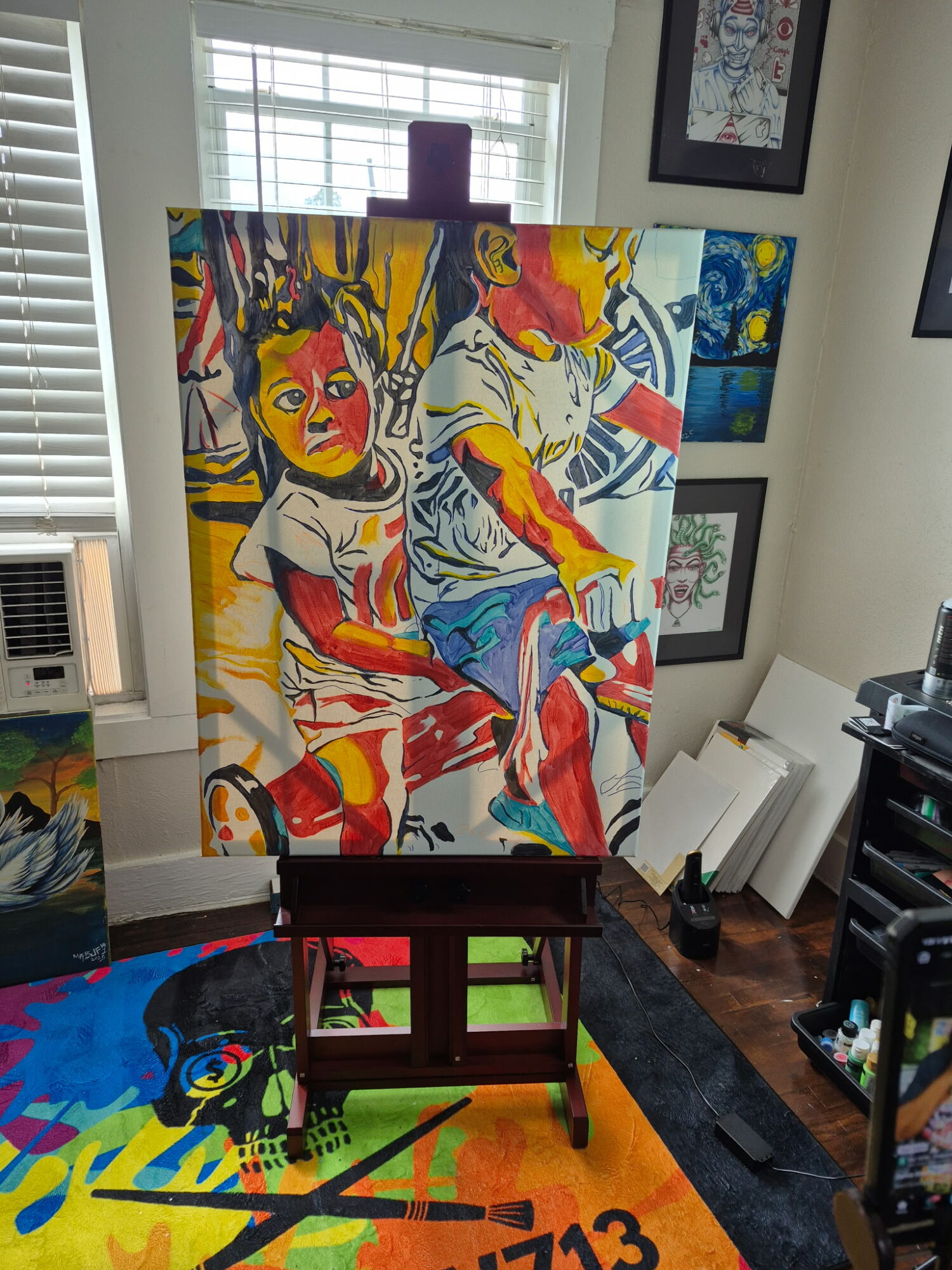 Colorful painting of two children, one with a yellow face and the other with a red face, sitting with abstract background.