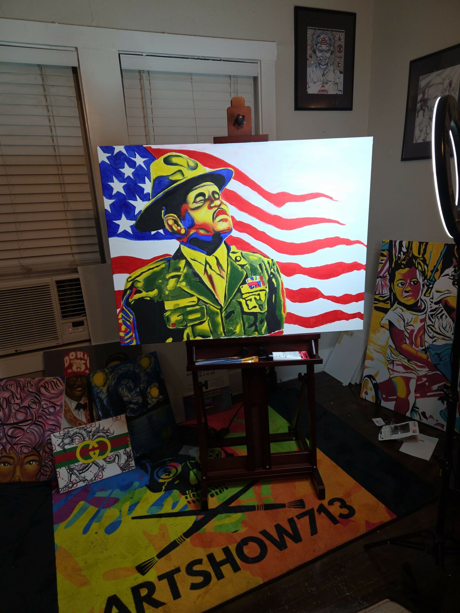 Television screen displays a colorful image of a person in military uniform with American flag elements and red and white stripes in the background.
