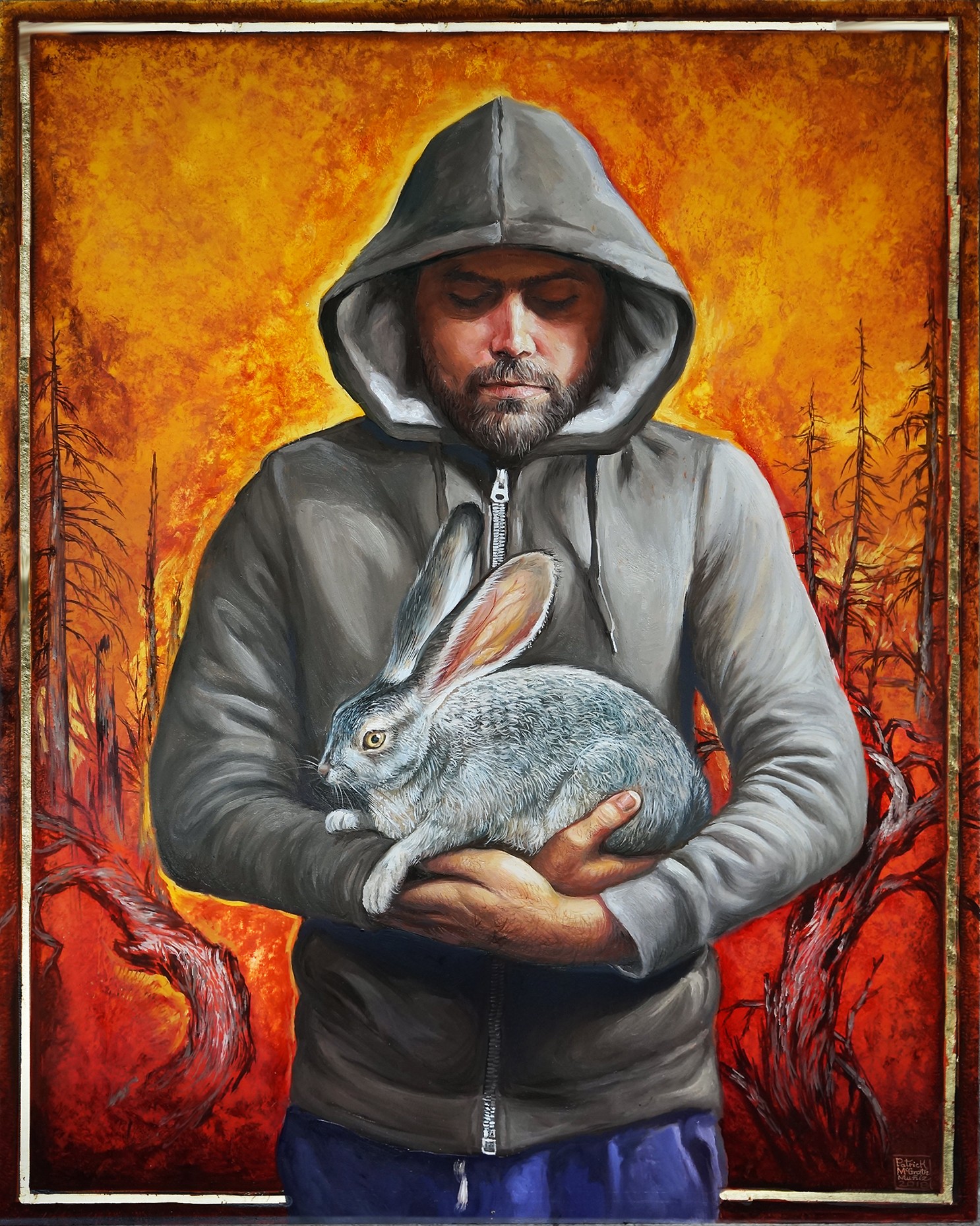 Man in hoodie holding a rabbit against a fiery orange background with trees.