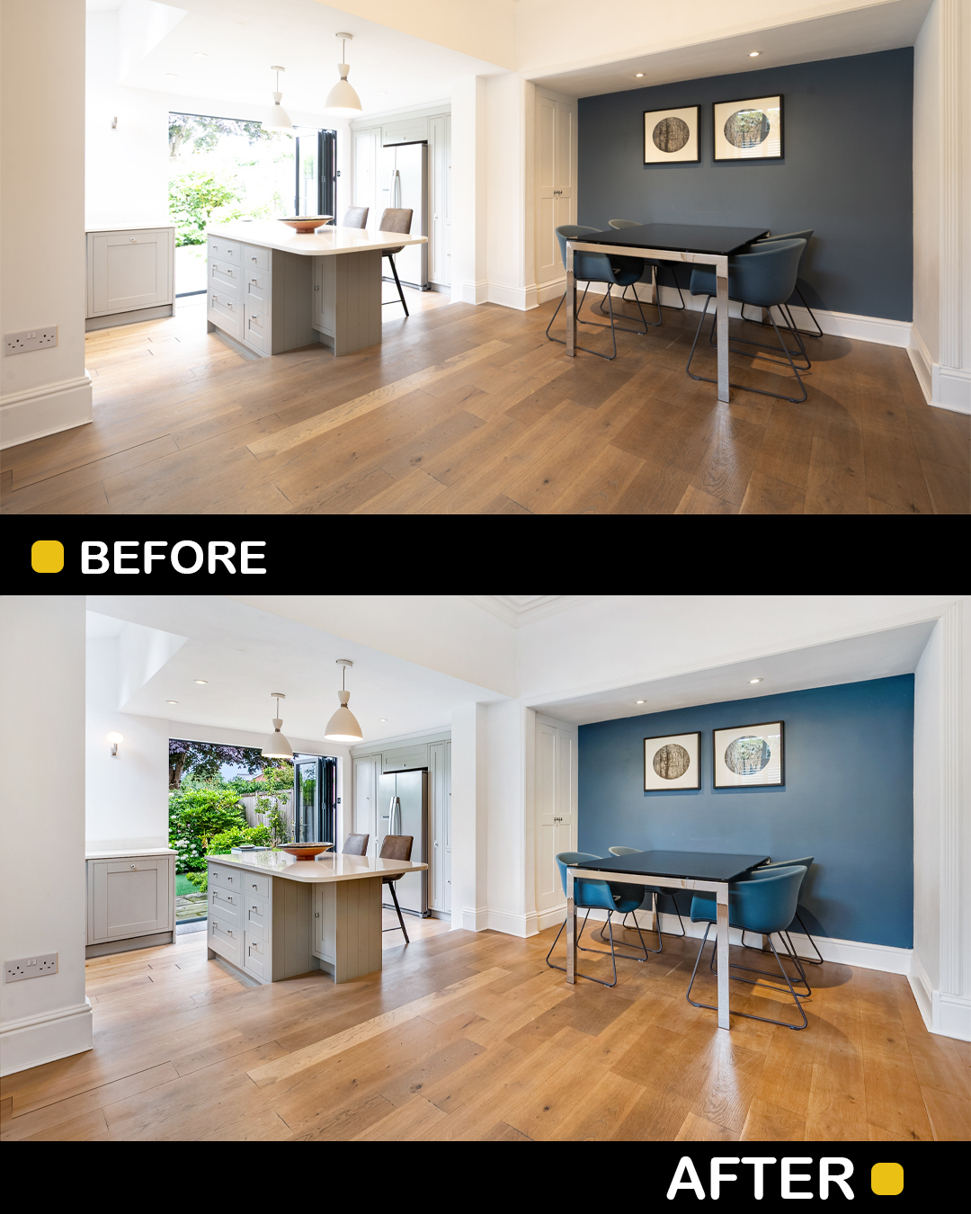 Living room with wooden floor, kitchen island, and a blue accent wall with framed art, bright natural light, and greenery outside.