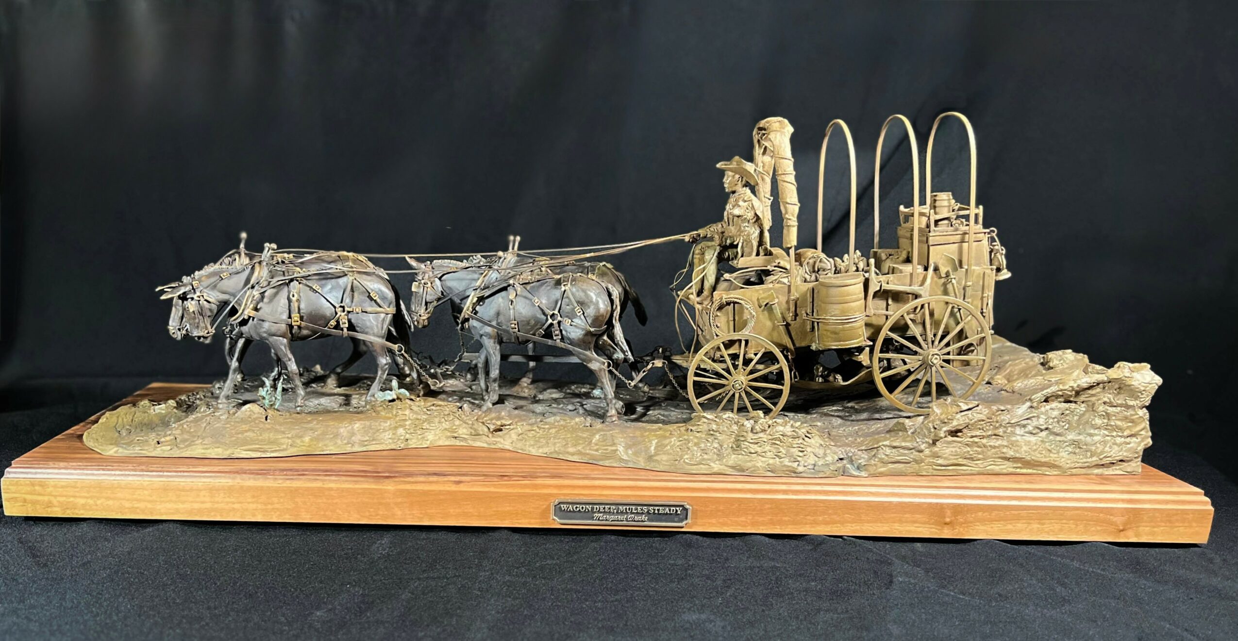 Detailed sculpture of a horse-drawn carriage with two horses and a driver, mounted on a wooden base.