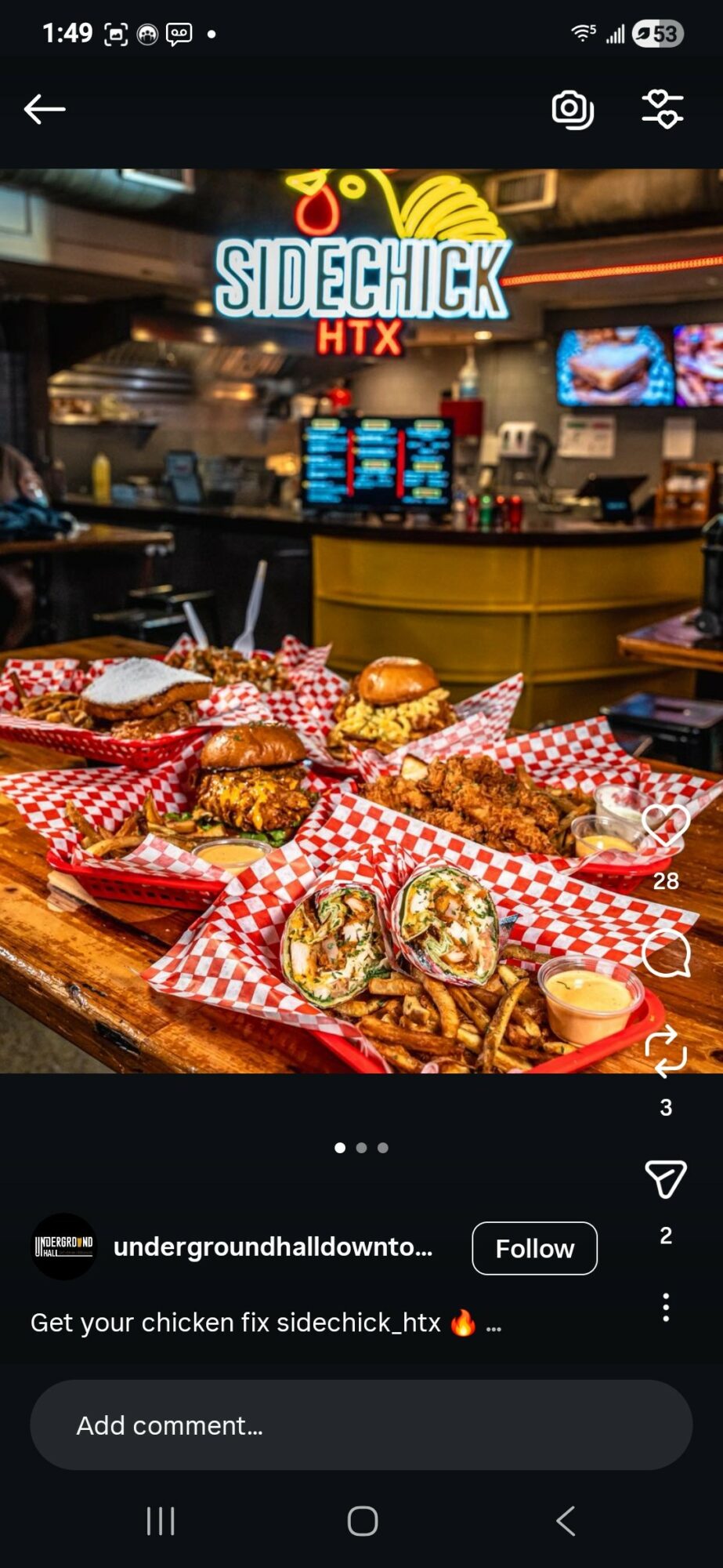Several chicken sandwiches on red checkered paper in front of a restaurant counter with a sign reading 'Sidechick HTX'.