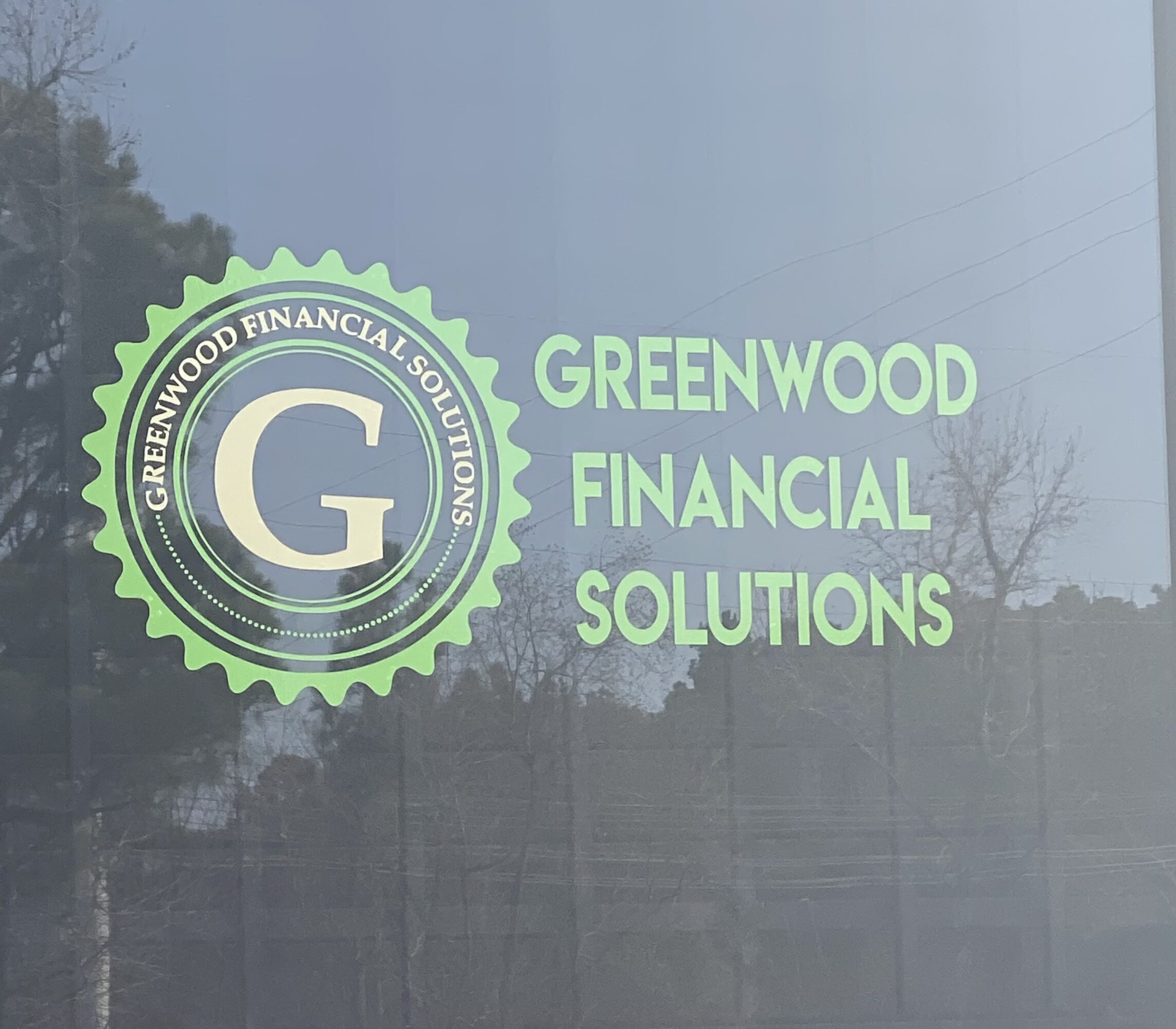 Greenwood Financial Solutions logo with a large letter G inside a green gear, and the company name in green text.