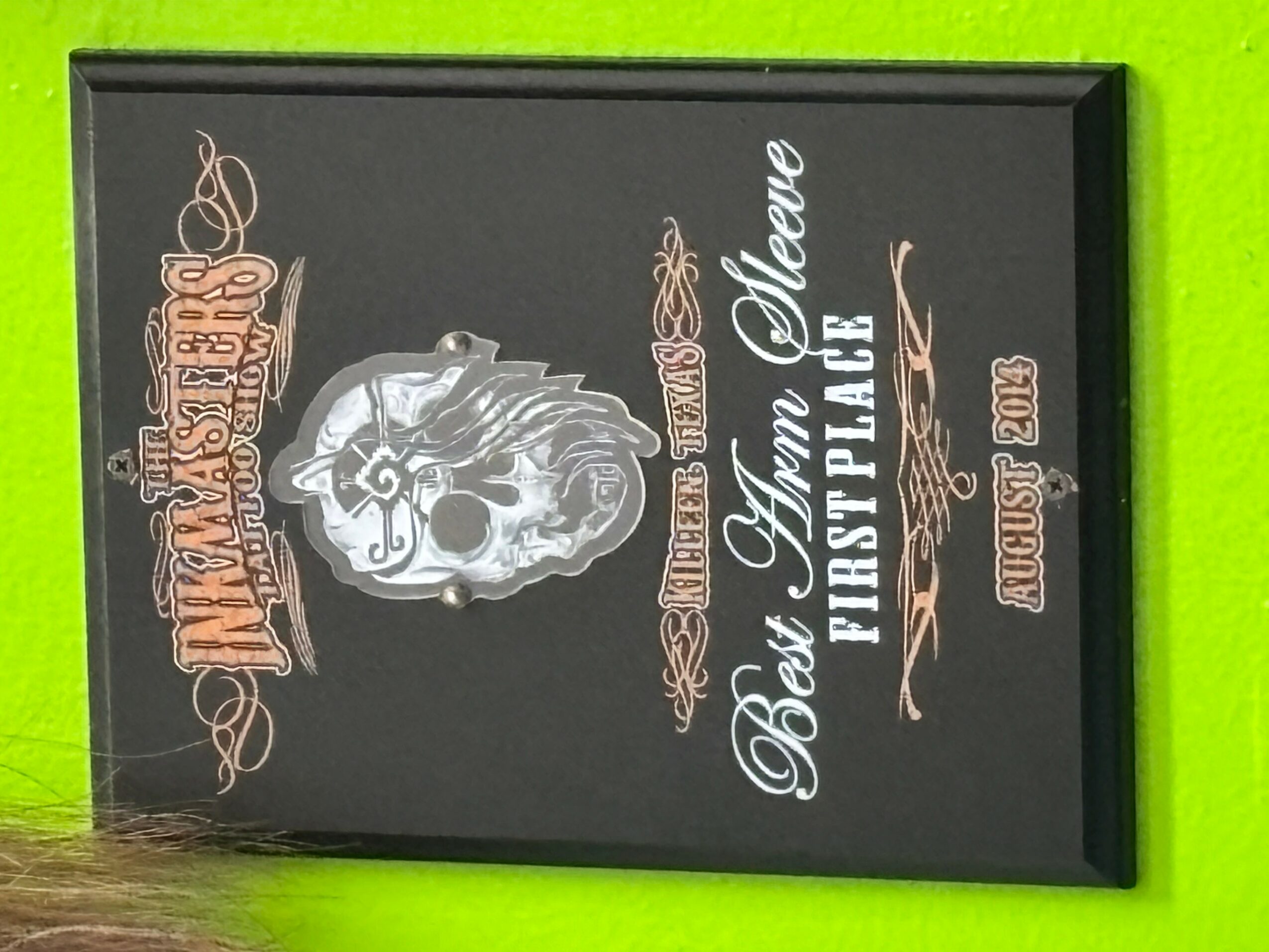 Framed poster with a skull and text about a motorcycle event, on a green background.