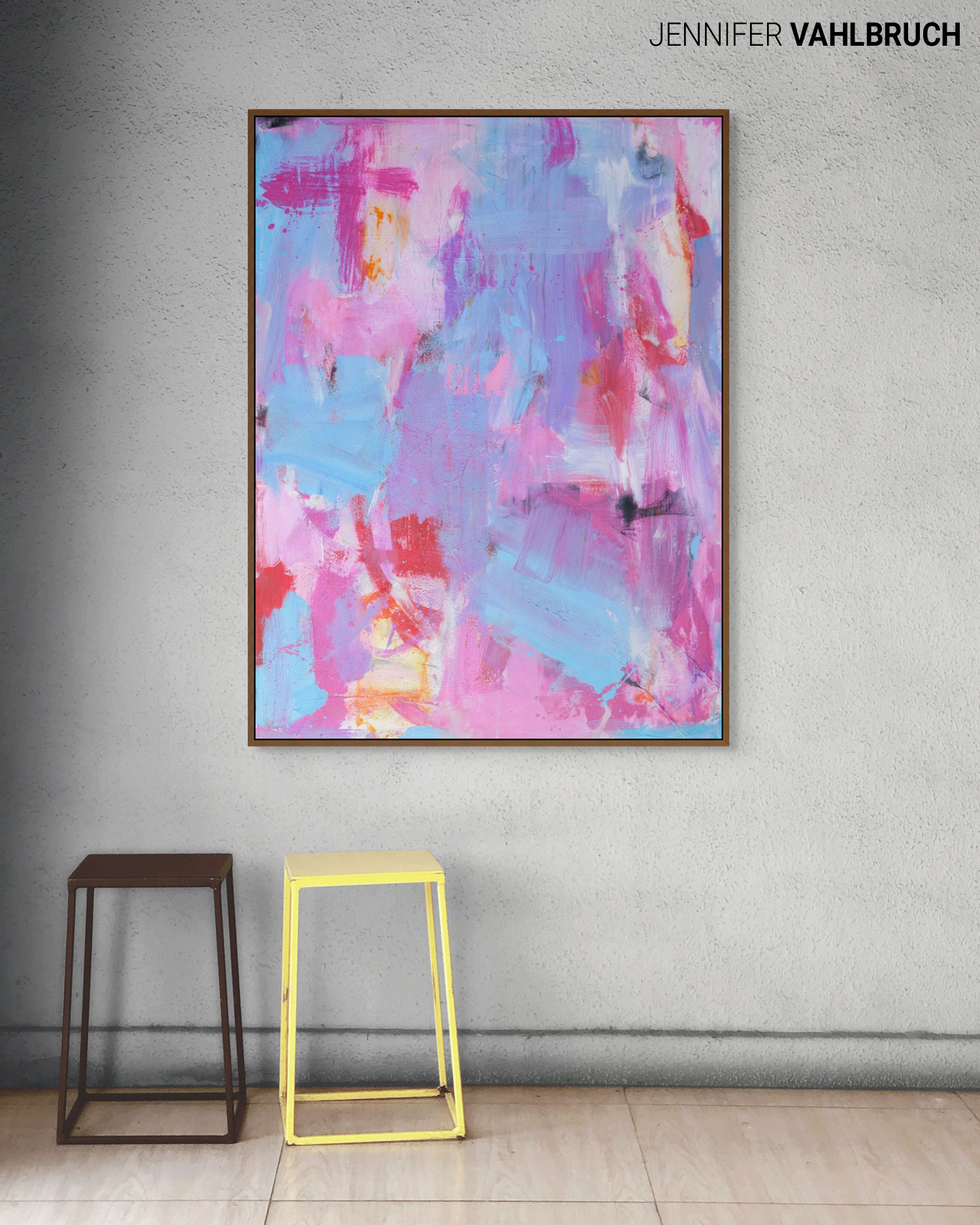 Abstract colorful painting with pink, blue, and purple hues on a wall, with two stools below, one brown and one yellow.
