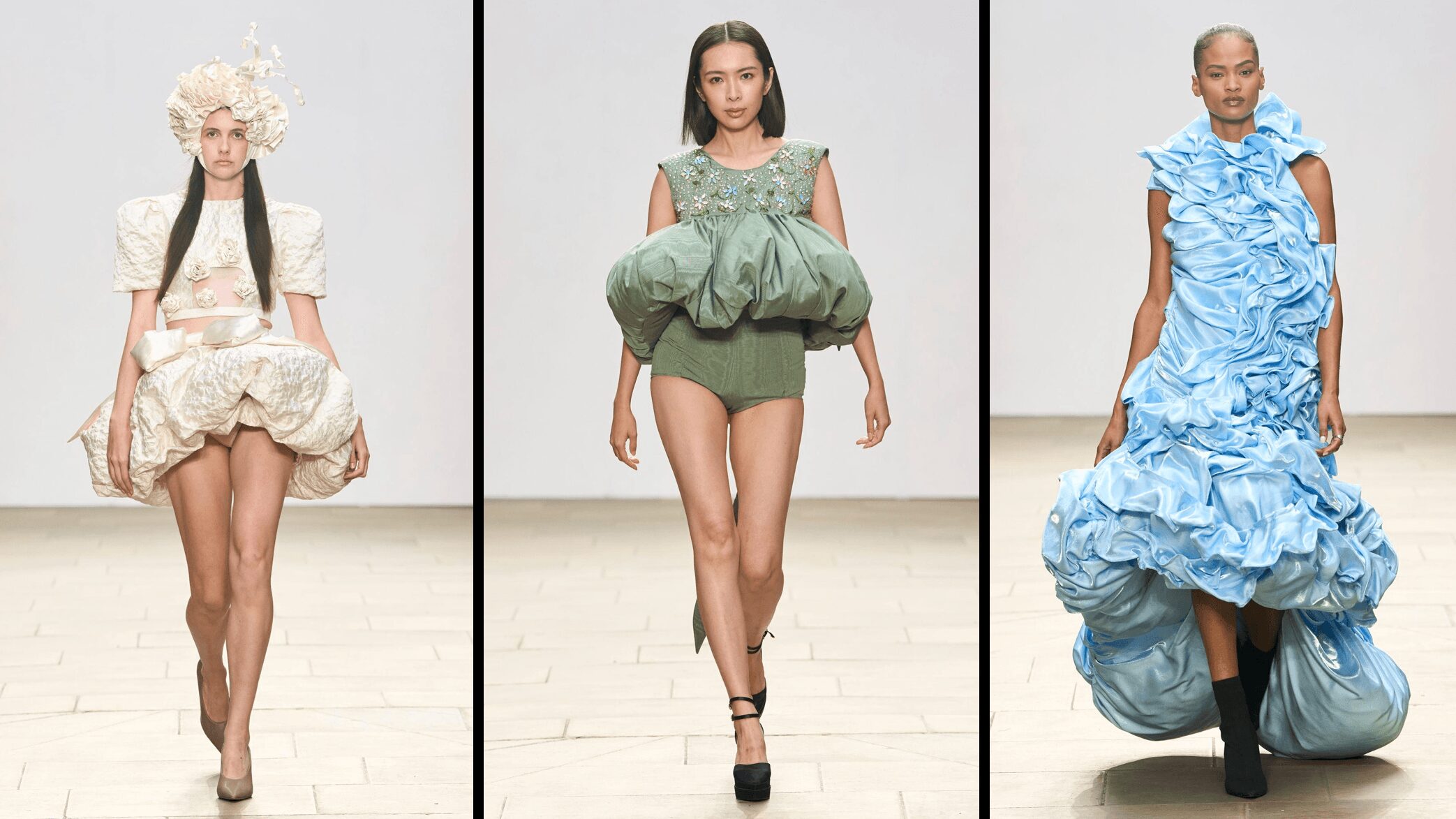 Three models walk runway in elaborate, colorful dresses with ruffles and volume, each wearing unique fashion styles.