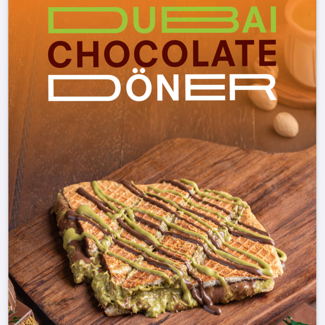 A sandwich with green filling and chocolate drizzle on a wooden board, with a small round object in the background.
