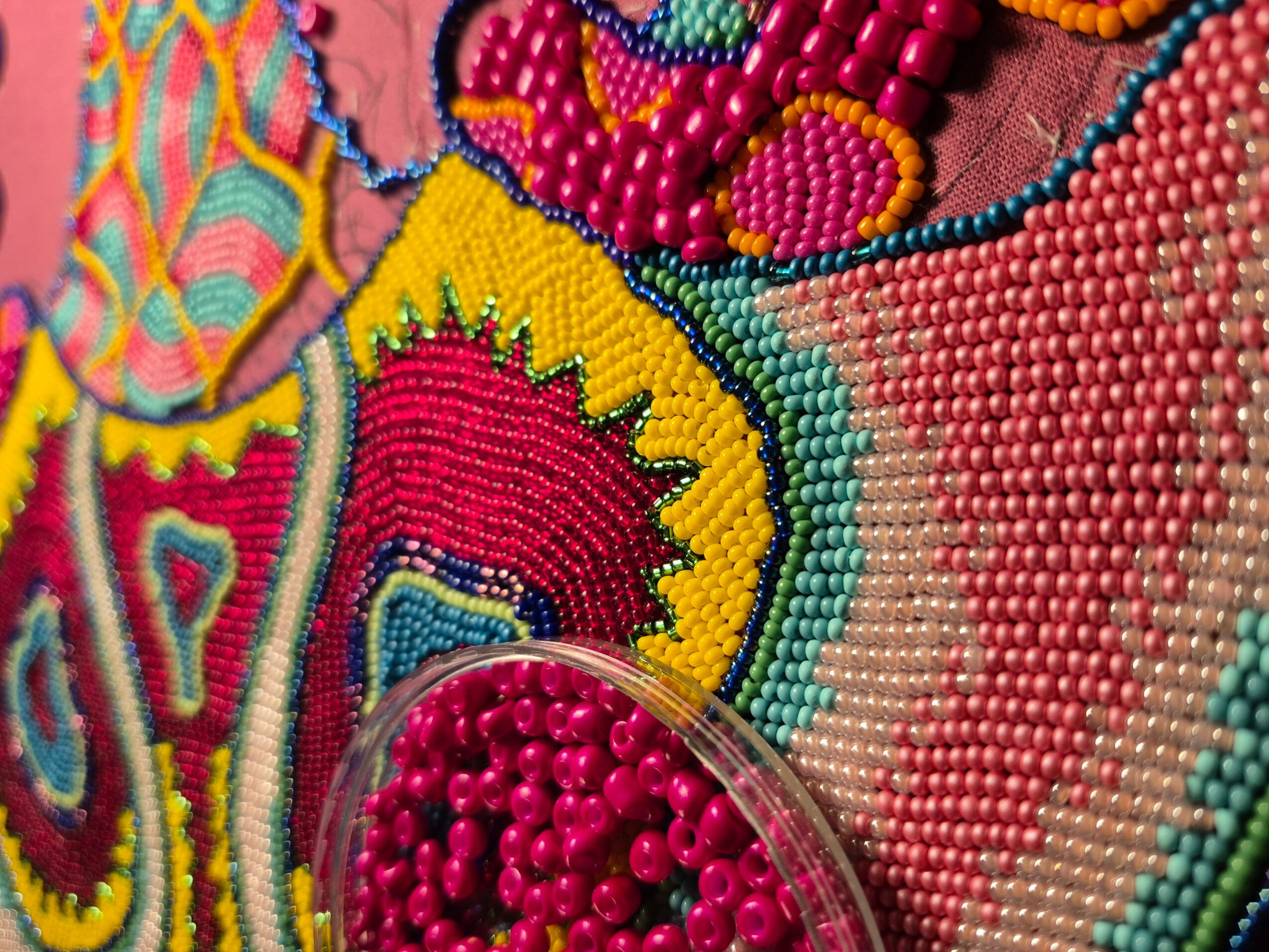 Close-up of colorful beaded embroidery with intricate patterns and bright colors.