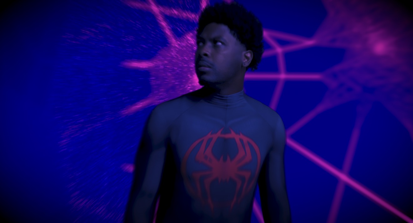 Young boy in Spider-Man costume with a glowing background, looking to the side.