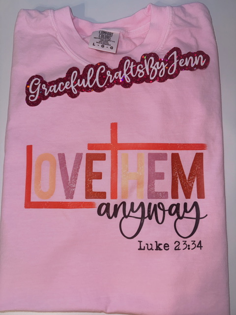 Pink T-shirt with text: 'GracefulCraftsByJenn', 'LOVE THEM anyway', and 'Luke 23:34'.