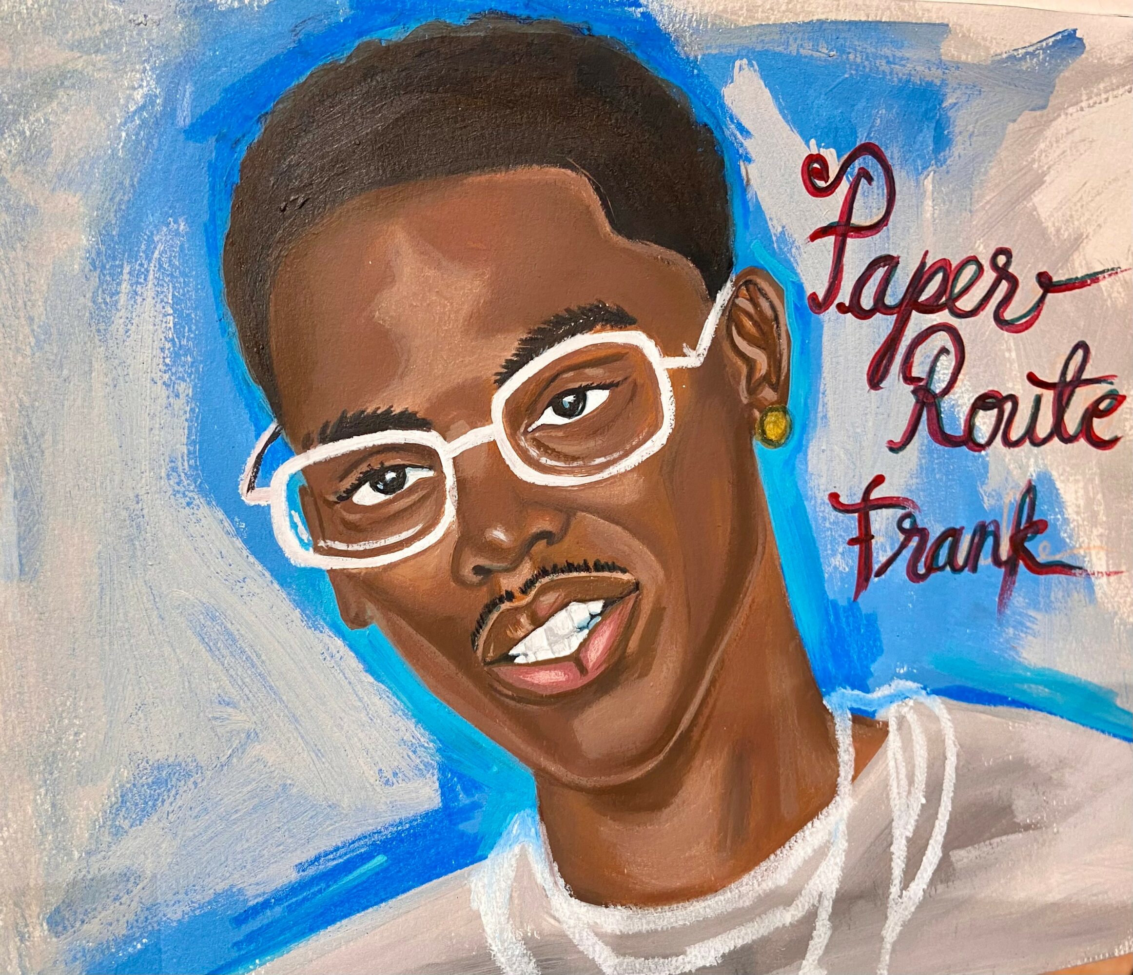 Portrait of a person with short hair, glasses, and earrings, with text reading 'Paper Route Frank' in red script.