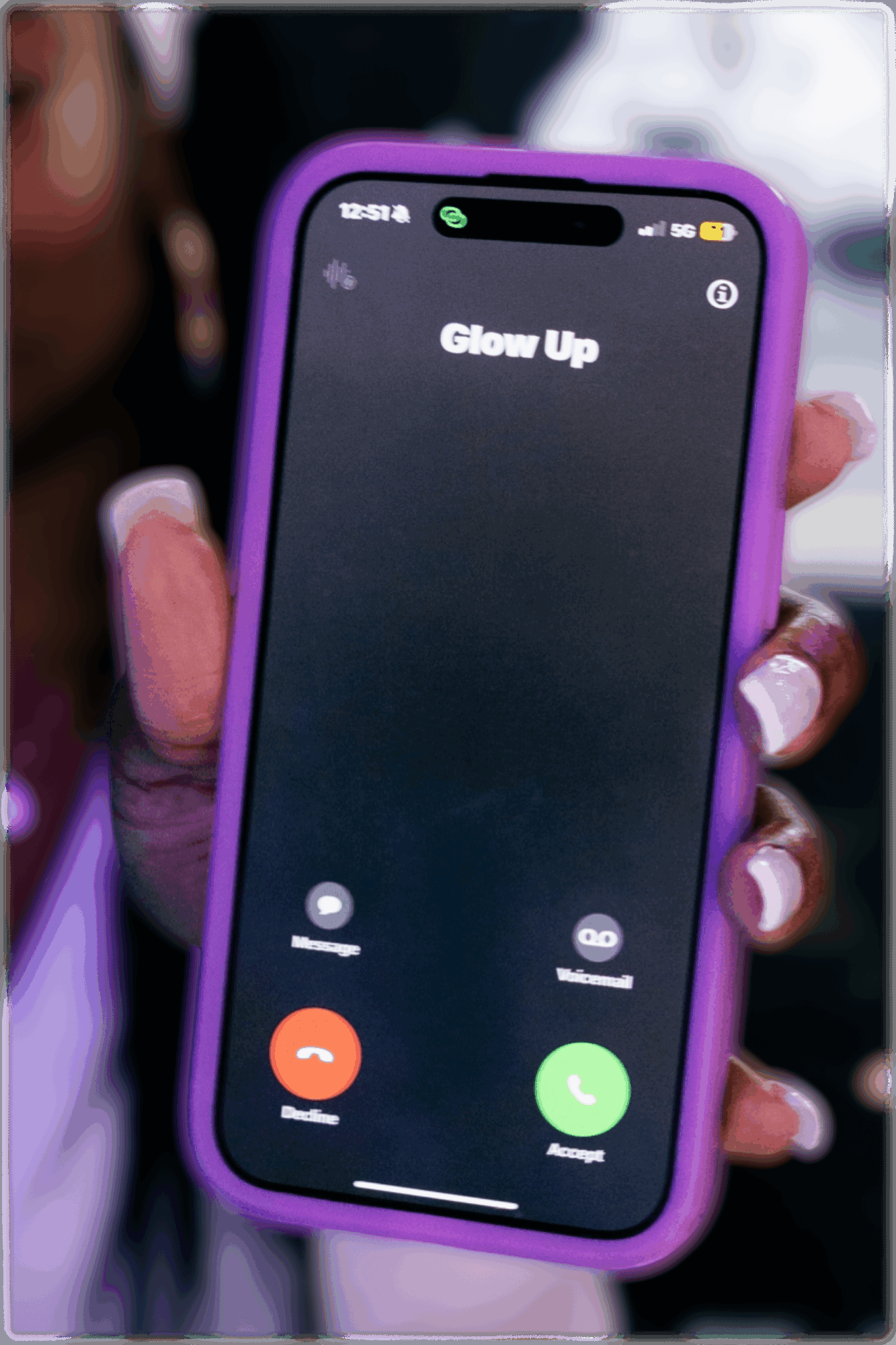 Person holding a smartphone with a purple case displaying an incoming call screen titled 'Glow Up'.