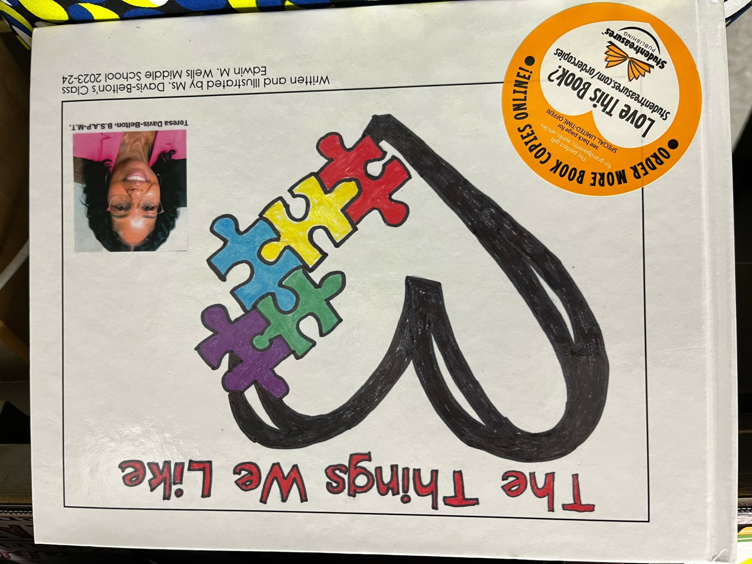 A drawing of a heart with colorful puzzle pieces and the text
