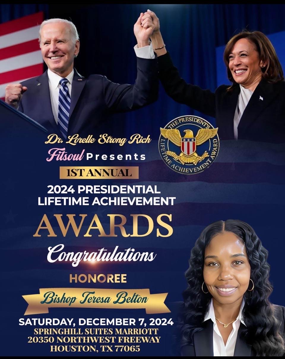 Two people holding hands and smiling on stage, with a blue background and event banner, celebrating awards ceremony.