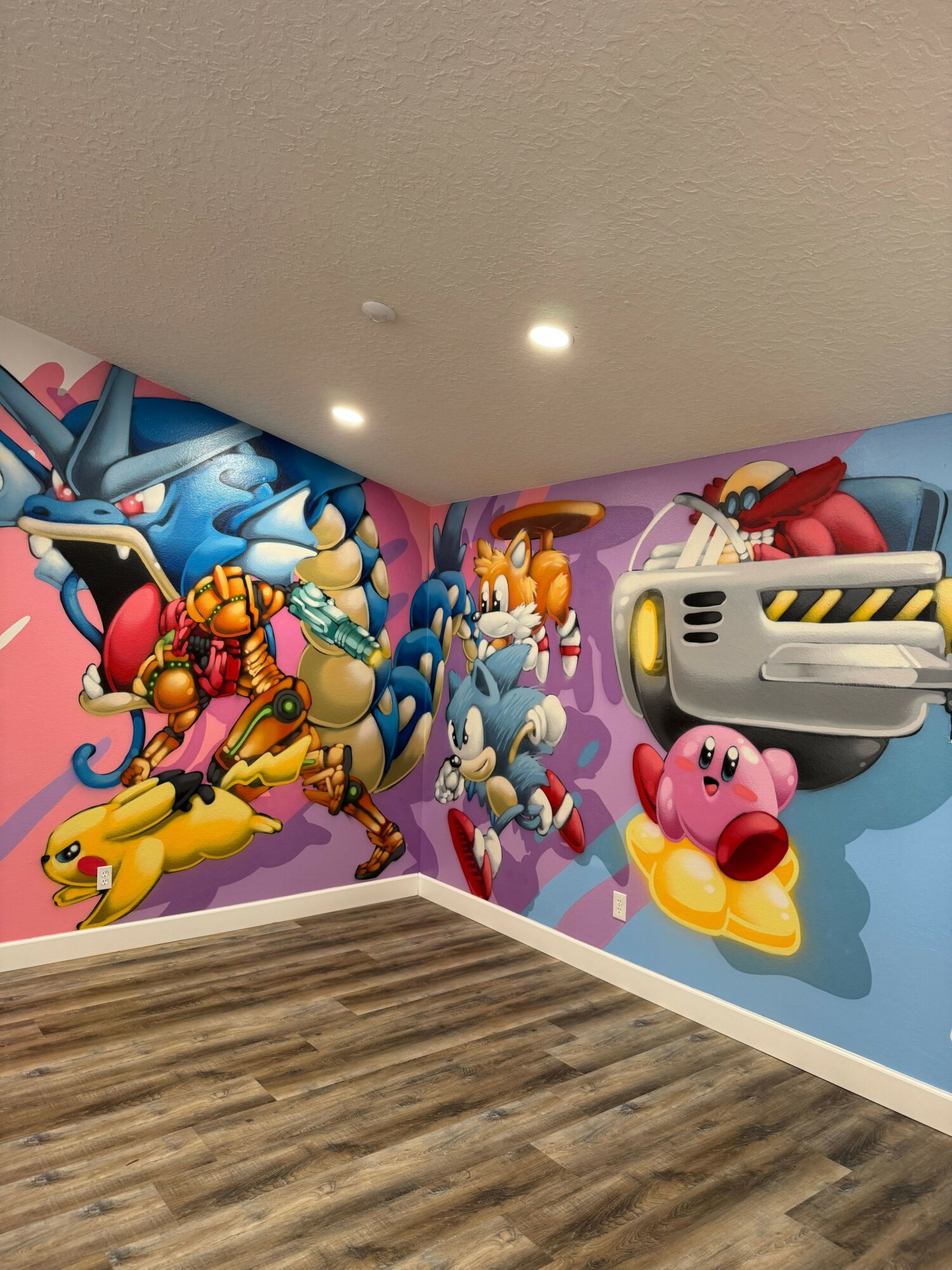 Colorful cartoon mural with animals and characters on a wall, with a wooden floor nearby.