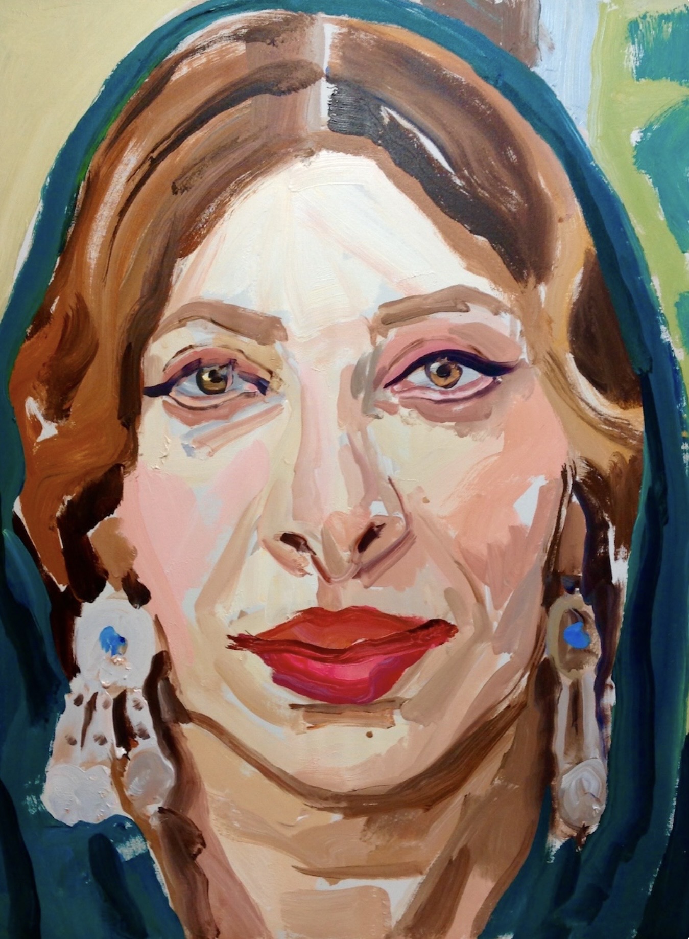 Portrait of a woman with red hair, blue earrings, and red lipstick, looking directly at the viewer.