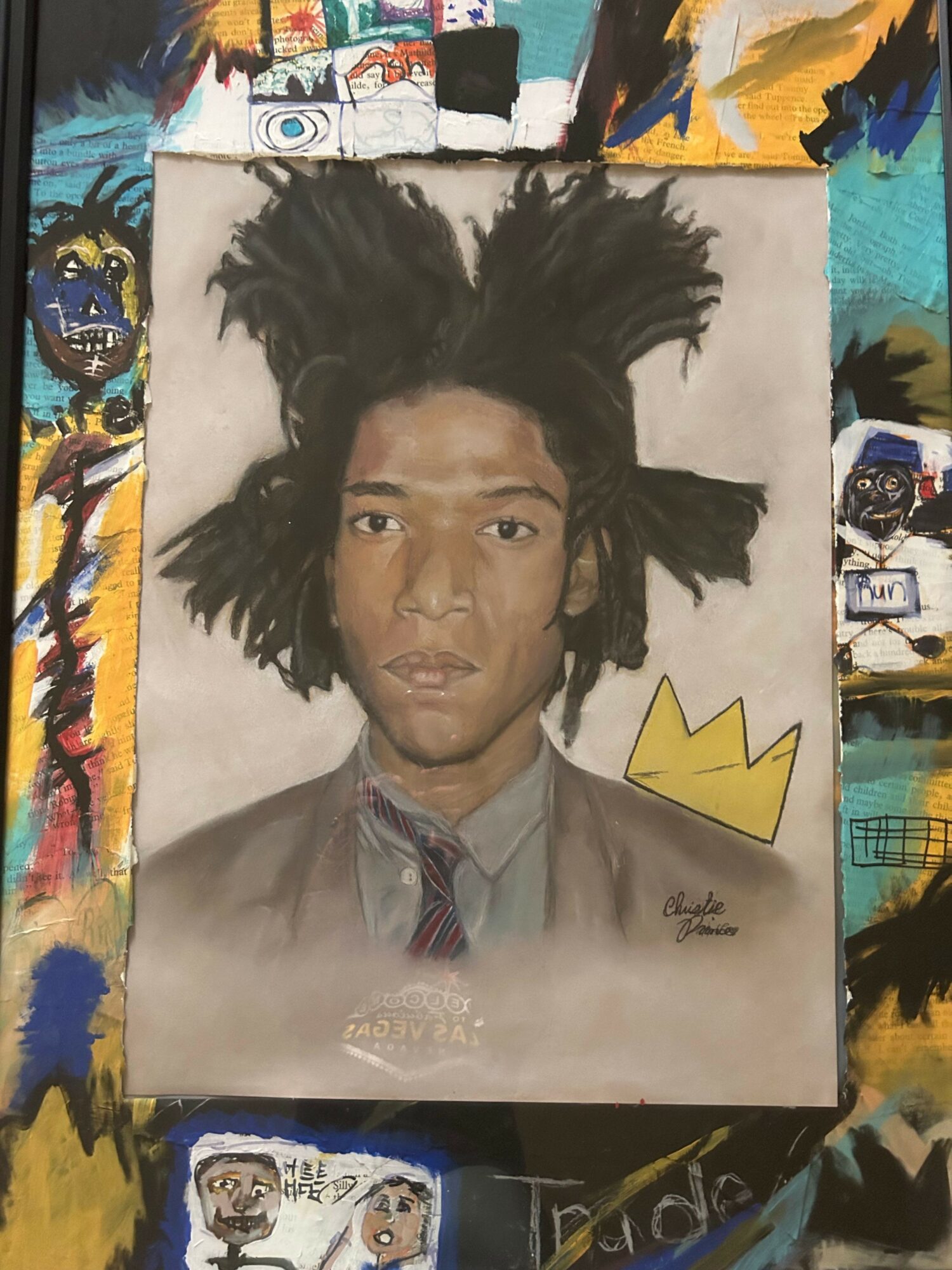 Portrait of a person with long, dark, curly hair, wearing a suit and tie, with a yellow crown drawing above their head.