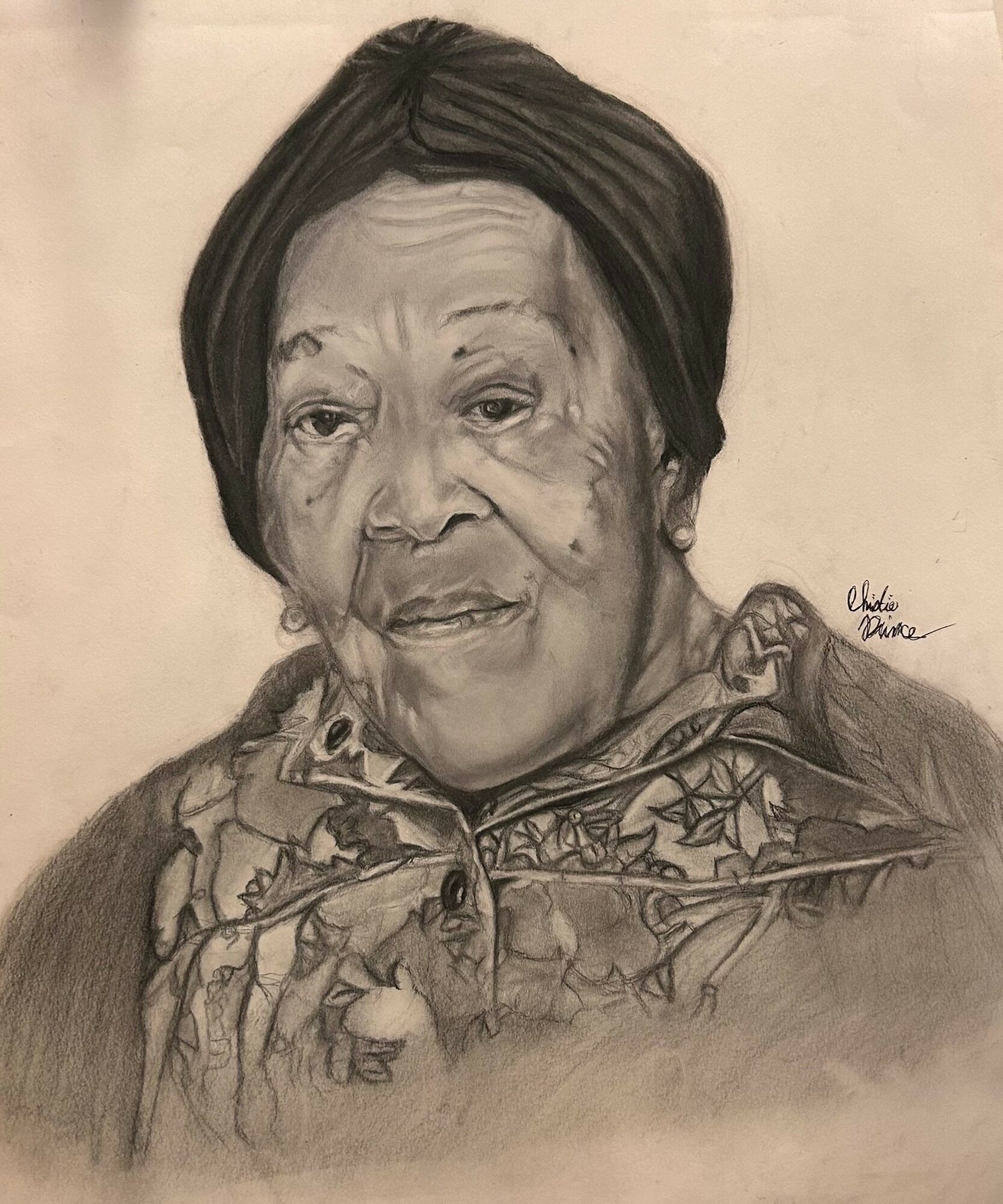 Detailed pencil portrait of an elderly woman with short hair, wearing a patterned scarf, looking directly at the viewer.