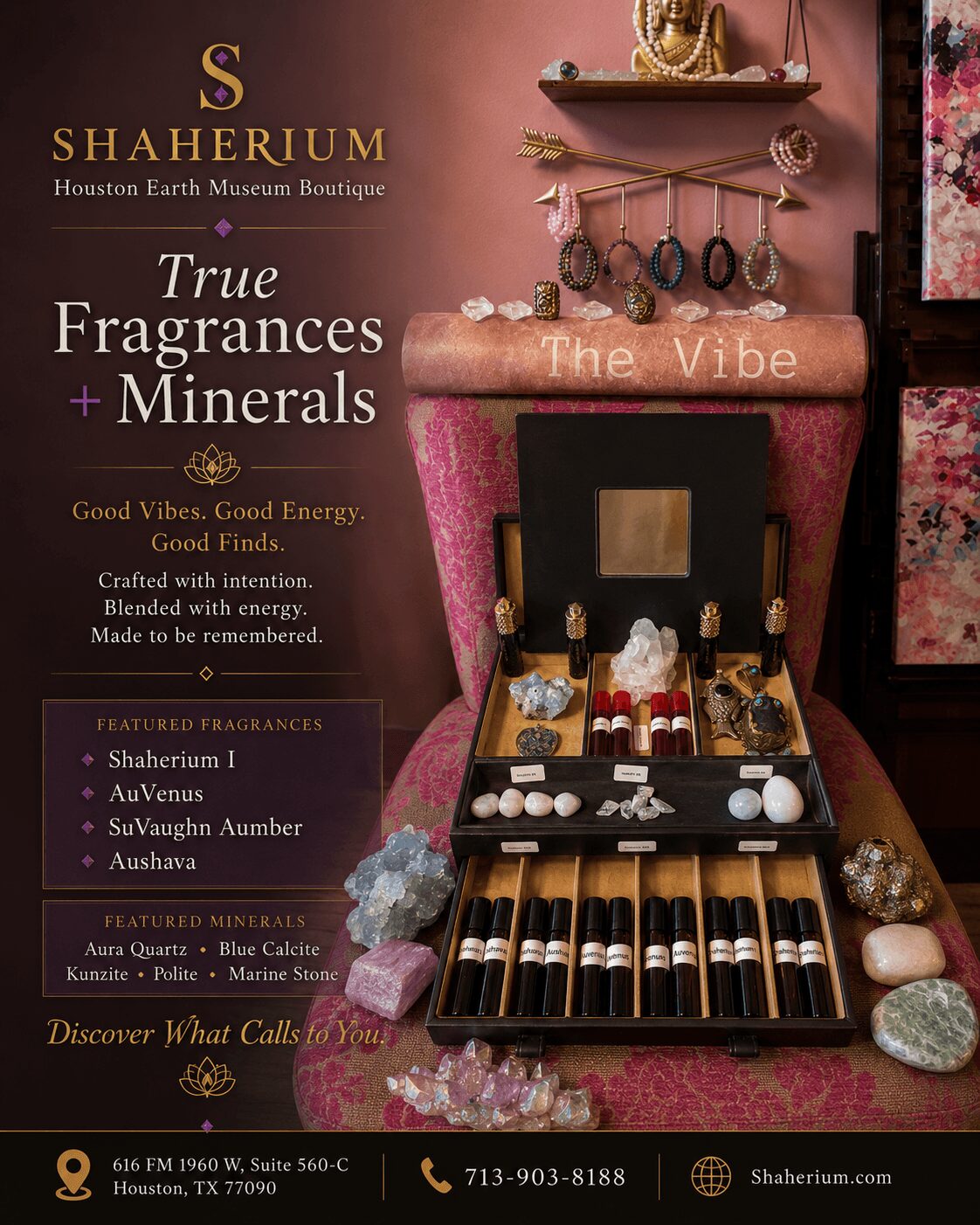 Display of jewelry and minerals on a pink velvet surface with a black box, rocks, and a sign for a fragrance boutique.