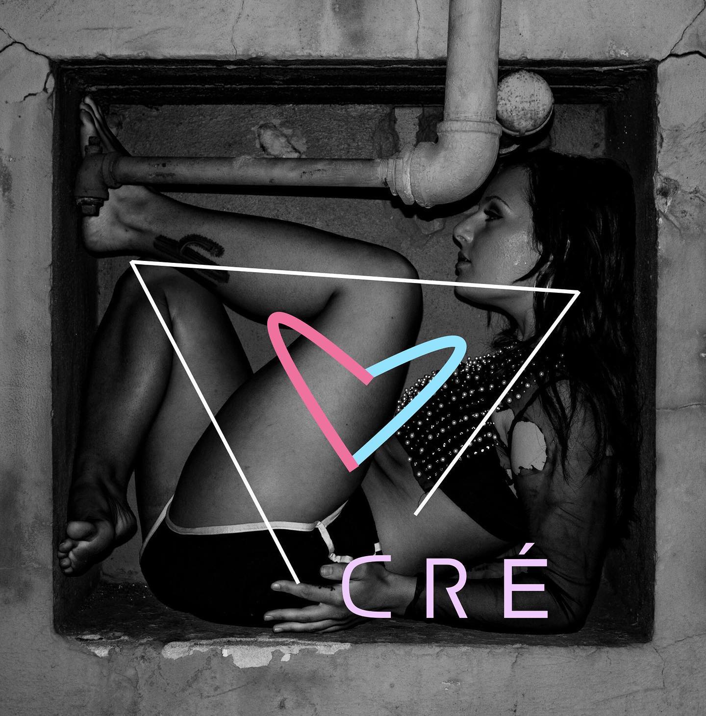 Woman sitting in a small, dark space with pipes, with a heart shape overlay and the word 'CRÉ' below.