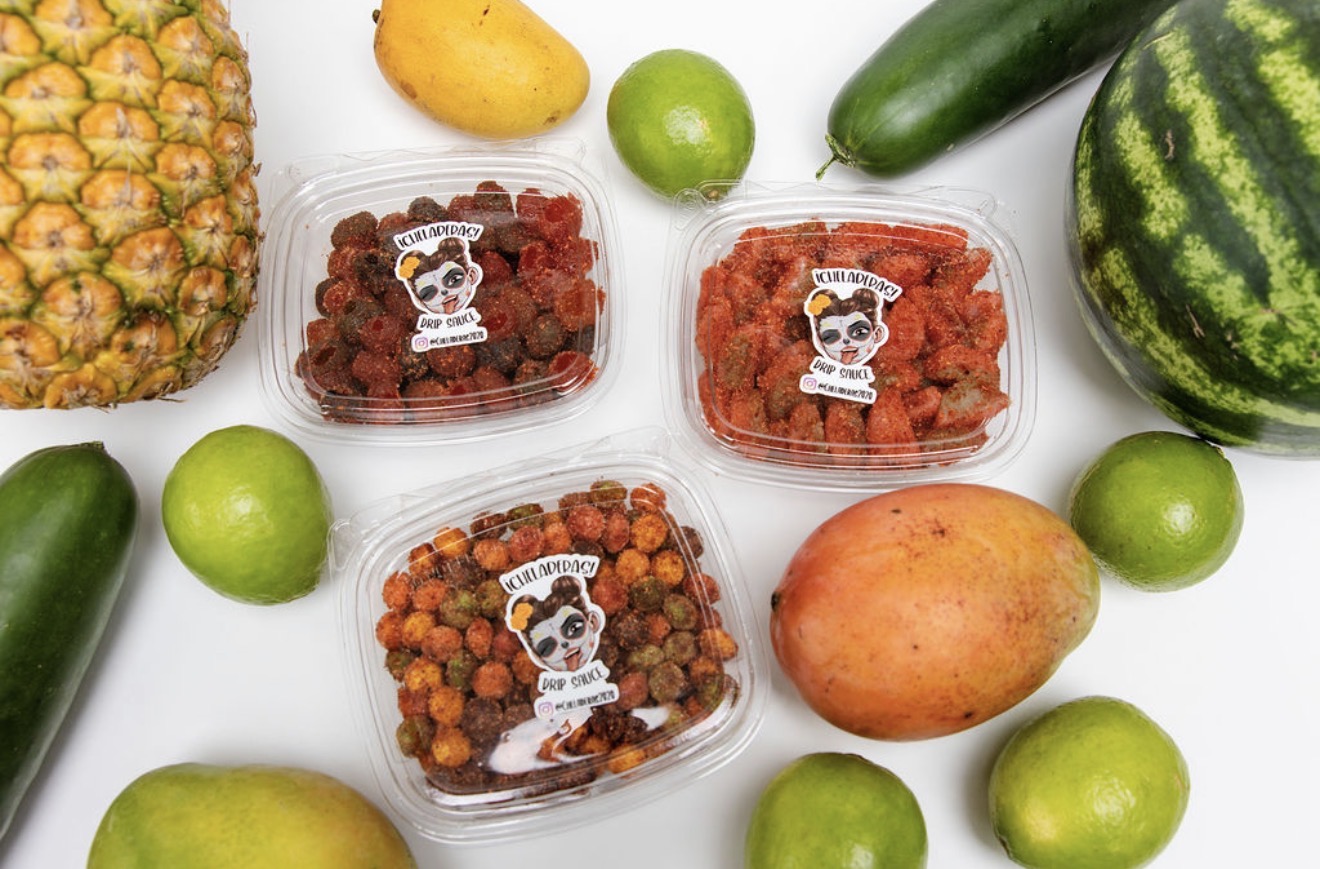 Assorted fruits and three containers of dried fruit snacks on a white background.