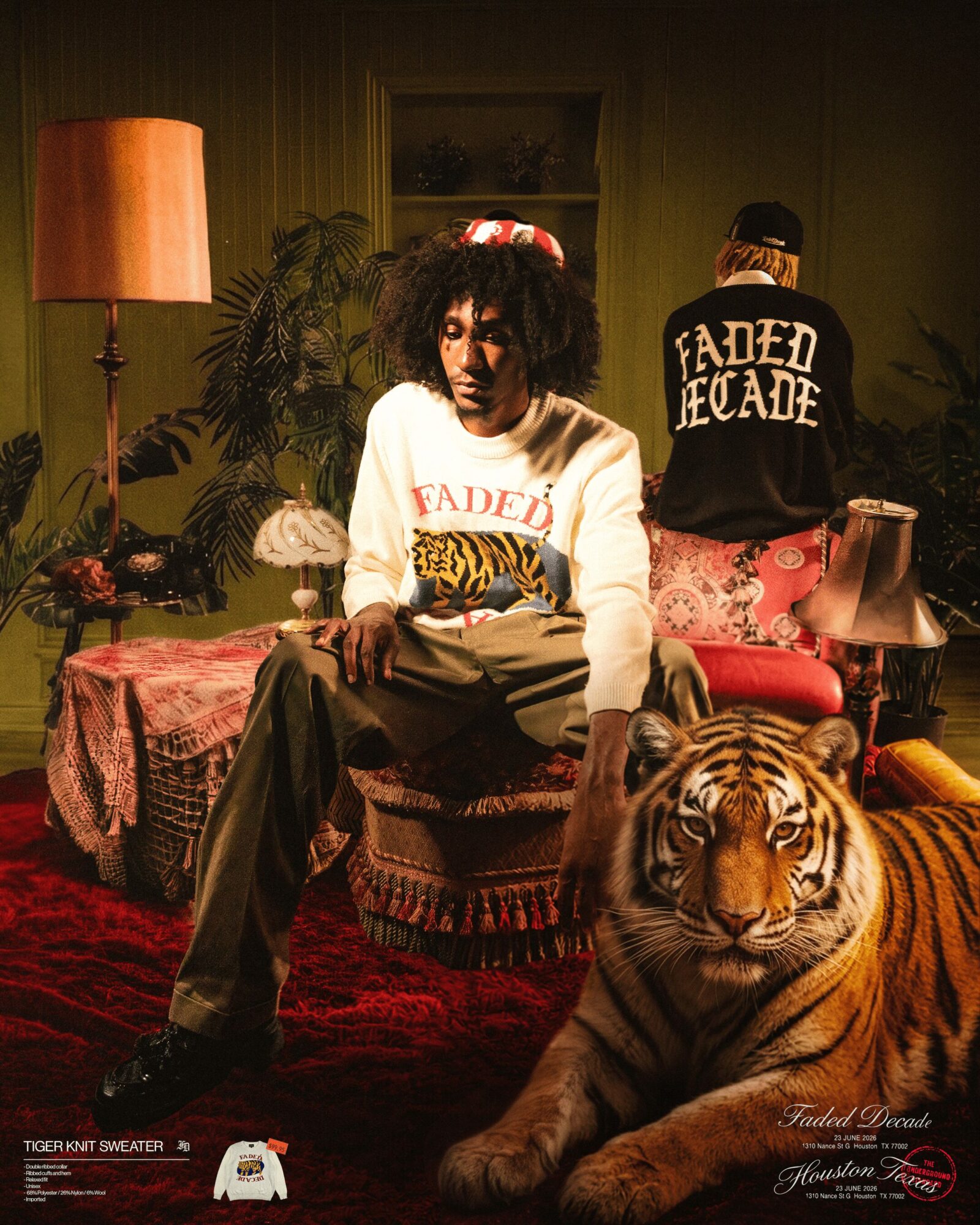Woman with curly hair sitting on a sofa with a tiger lying in front, two people in the background, warm lighting.