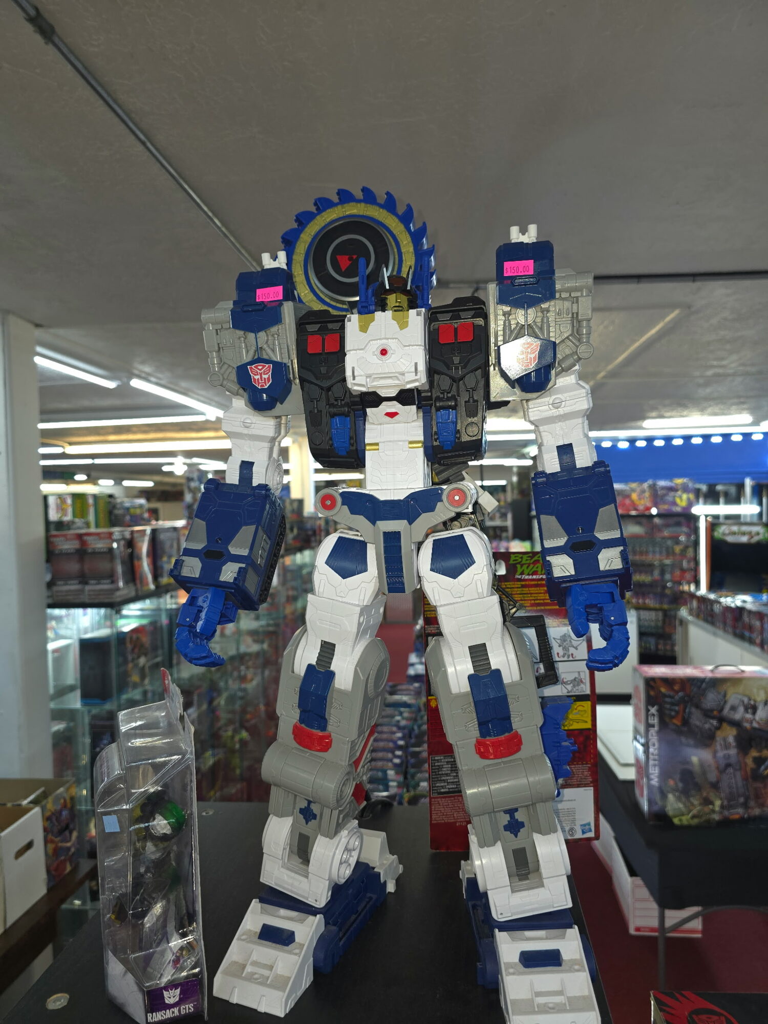 A large robot figure made of building blocks stands in a store aisle, with shelves and products in the background.