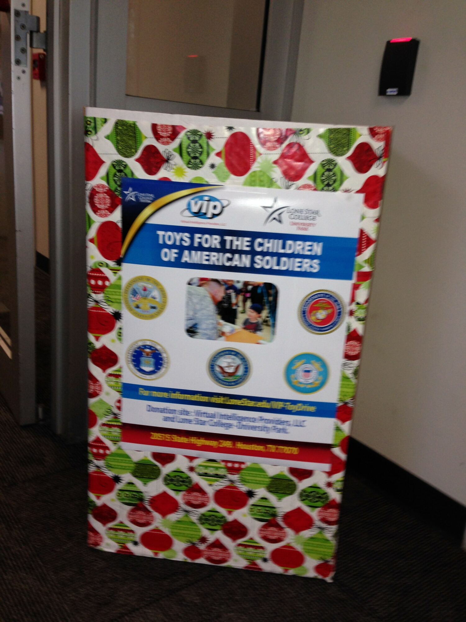 A colorful display board with holiday-themed decorations and a sign supporting American soldiers, featuring images and logos.