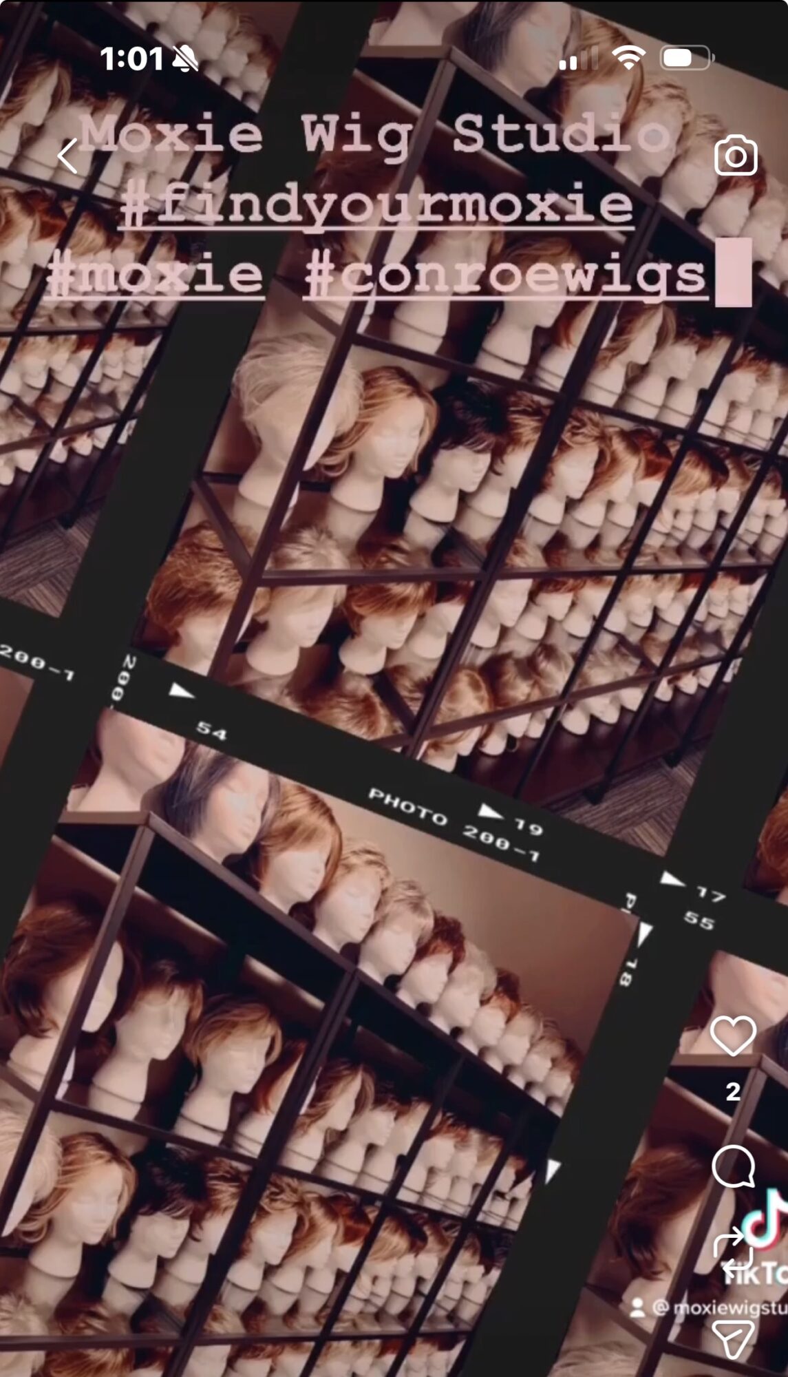 Multiple shelves with wigs in various shades and styles, arranged in rows inside a store or studio.