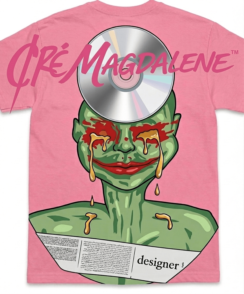Pink T-shirt with a cartoonish green face, a CD on the forehead, and tears, with text 'Dre Magdalen' and 'designer!'.