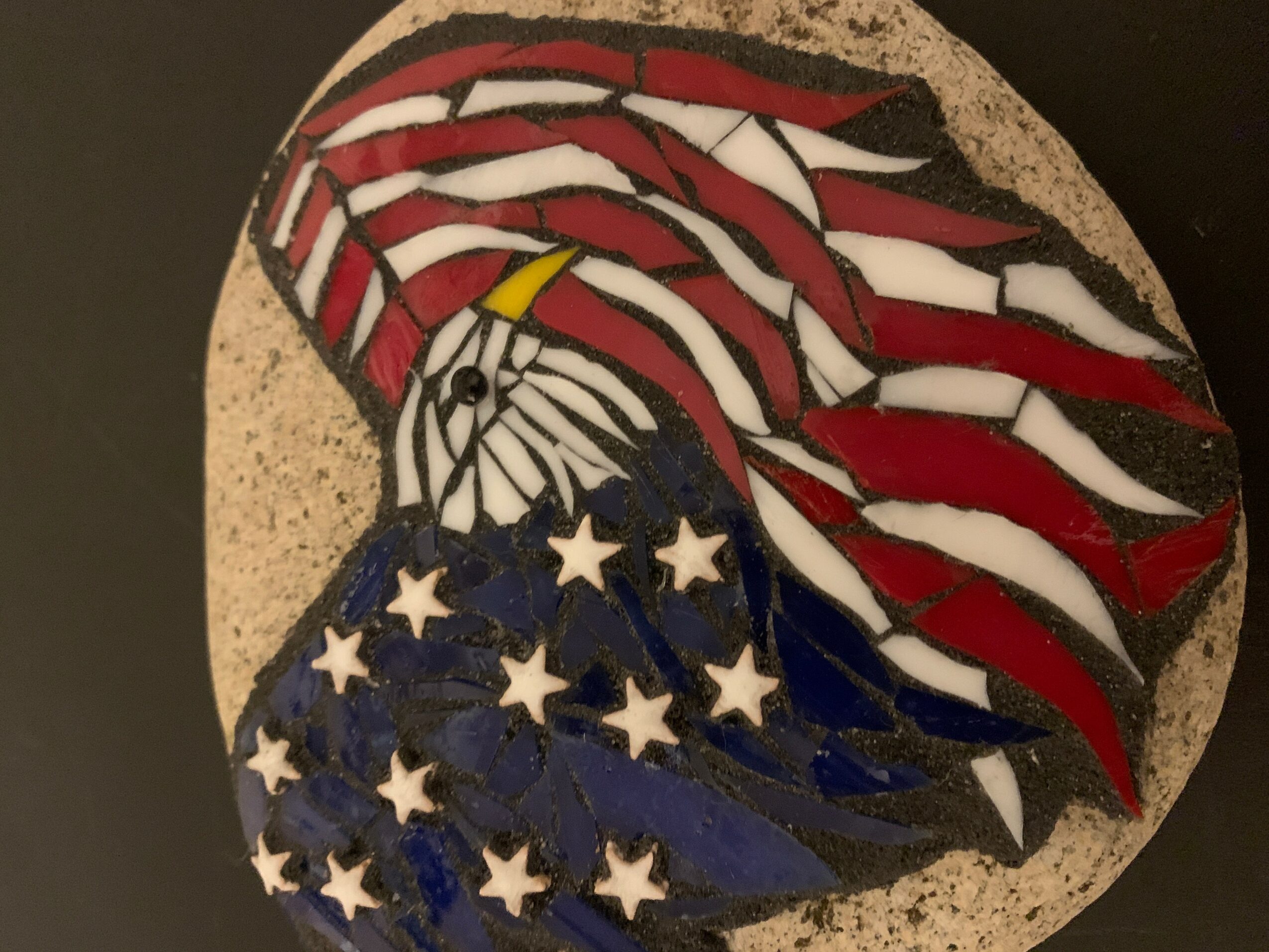 Mosaic of an eagle with an American flag design, featuring red and white stripes and a blue field with white stars.