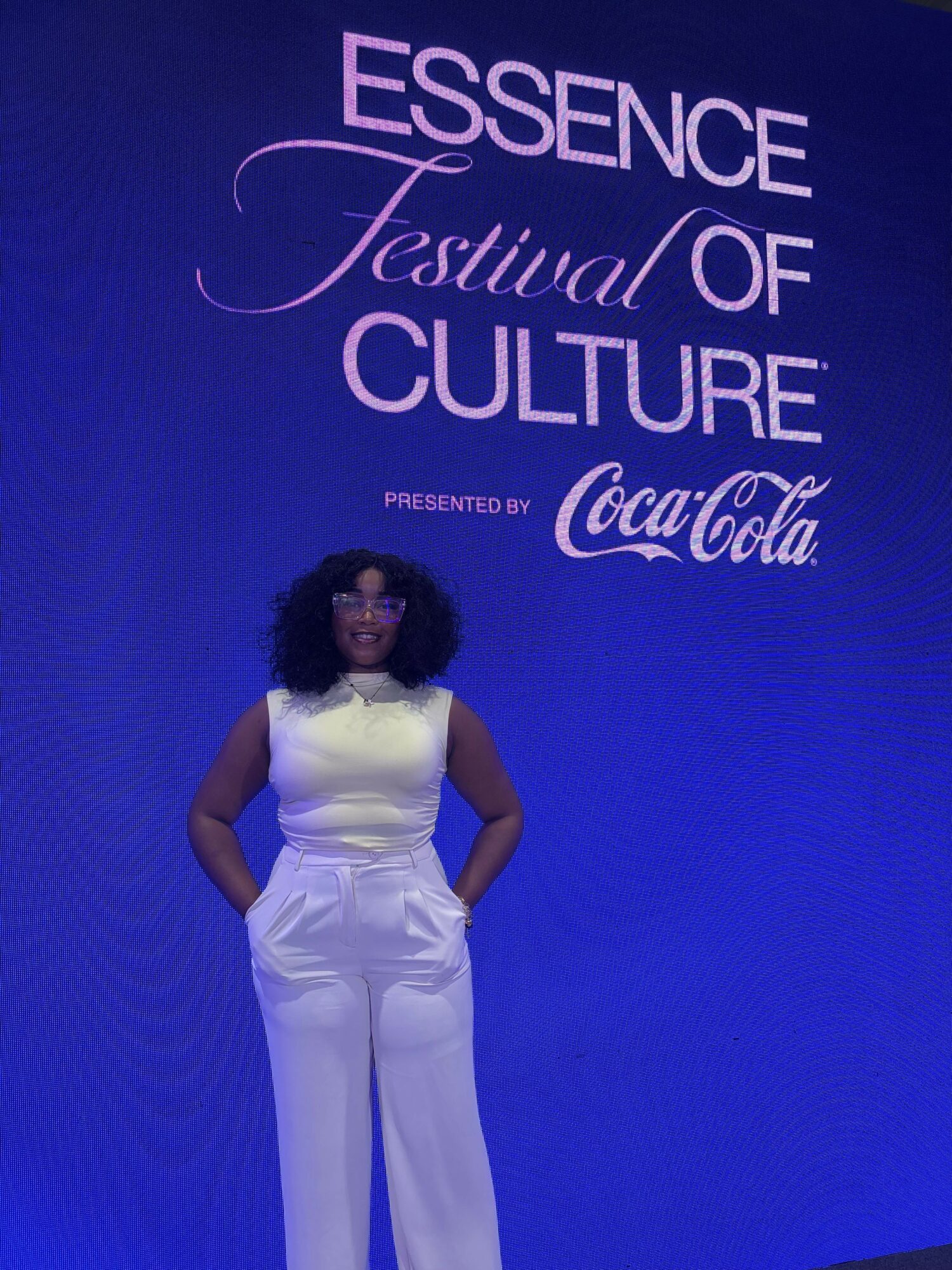 Woman in white dress standing against a blue background with text about essence of festival and culture, Coca-Cola logo.