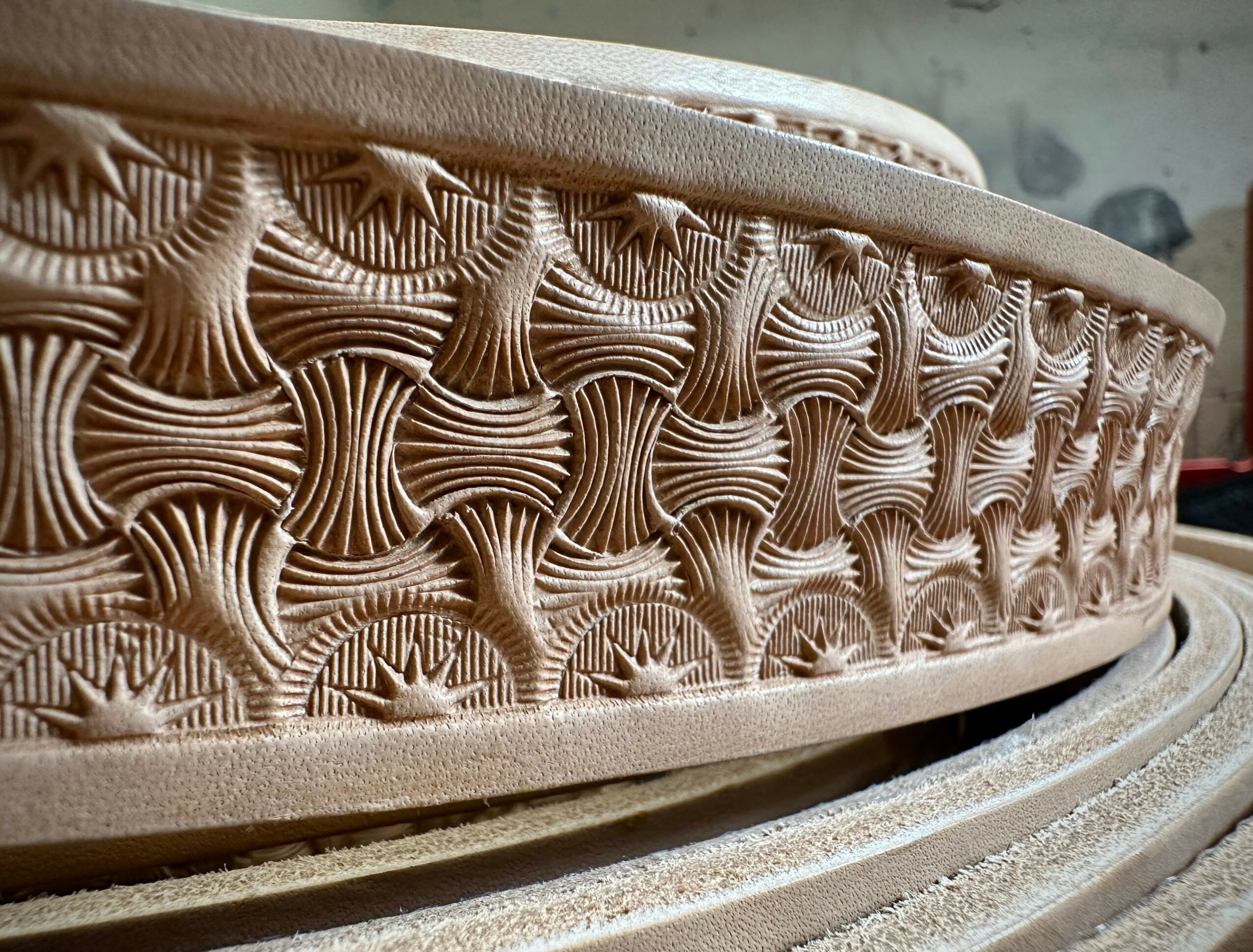 Close-up of a carved wooden object with intricate geometric patterns, showing detailed craftsmanship.