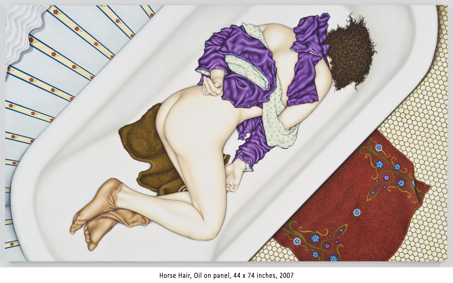 A doll with curly hair and purple clothing lying on a white surface, surrounded by patterned fabrics.