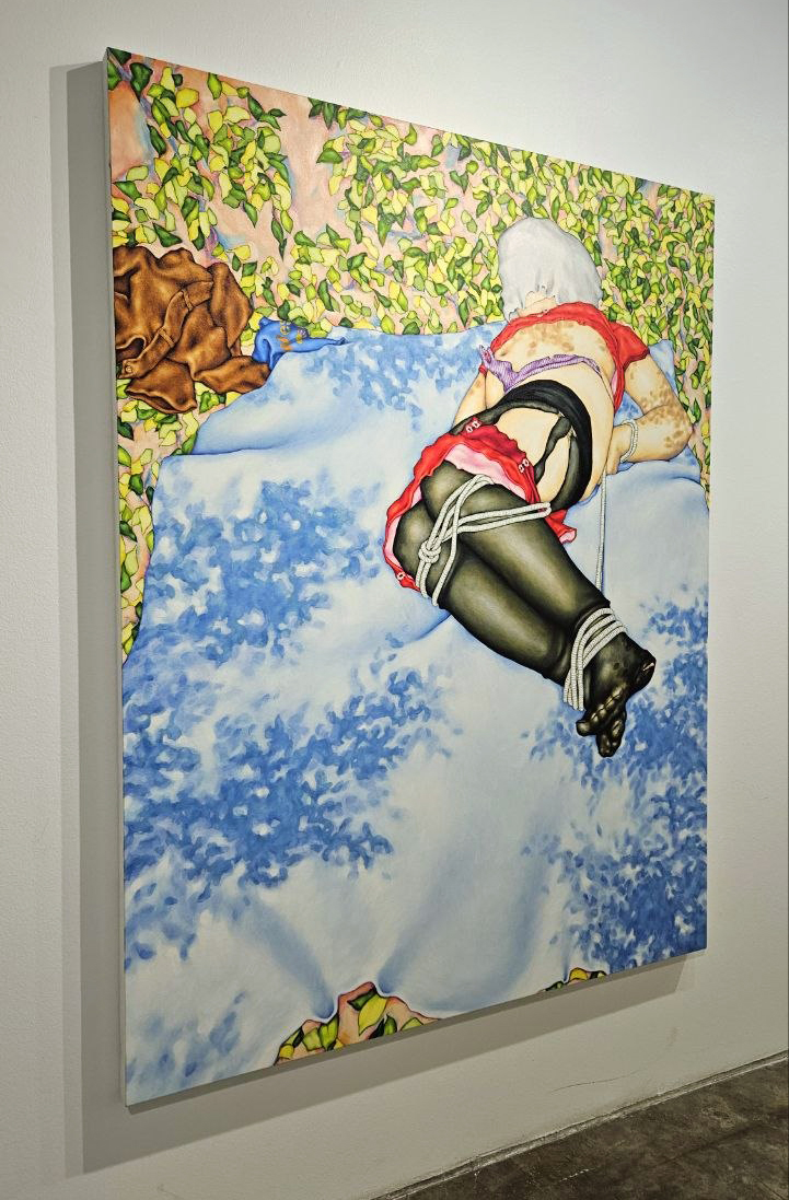 Person lying on a cloud with a sky background, wearing black stockings and red lingerie, viewed from behind.