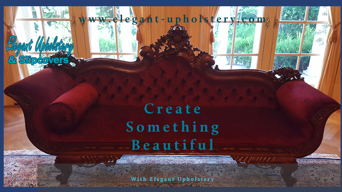 Elegant vintage sofa with ornate wood carvings, red upholstery, and two matching pillows in a bright room with large windows.