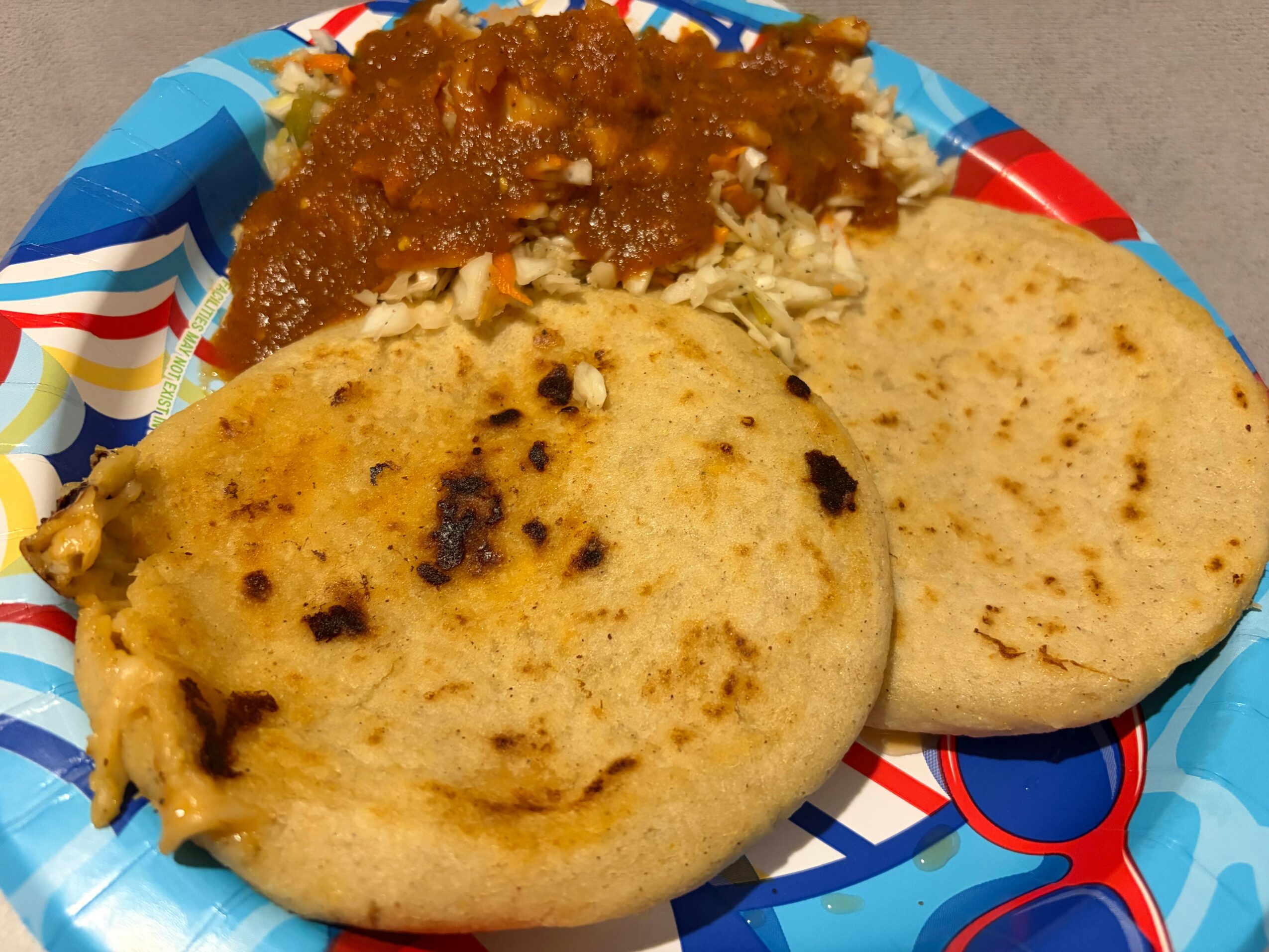 Two pieces of bread with a side of curry and rice on a colorful plate.