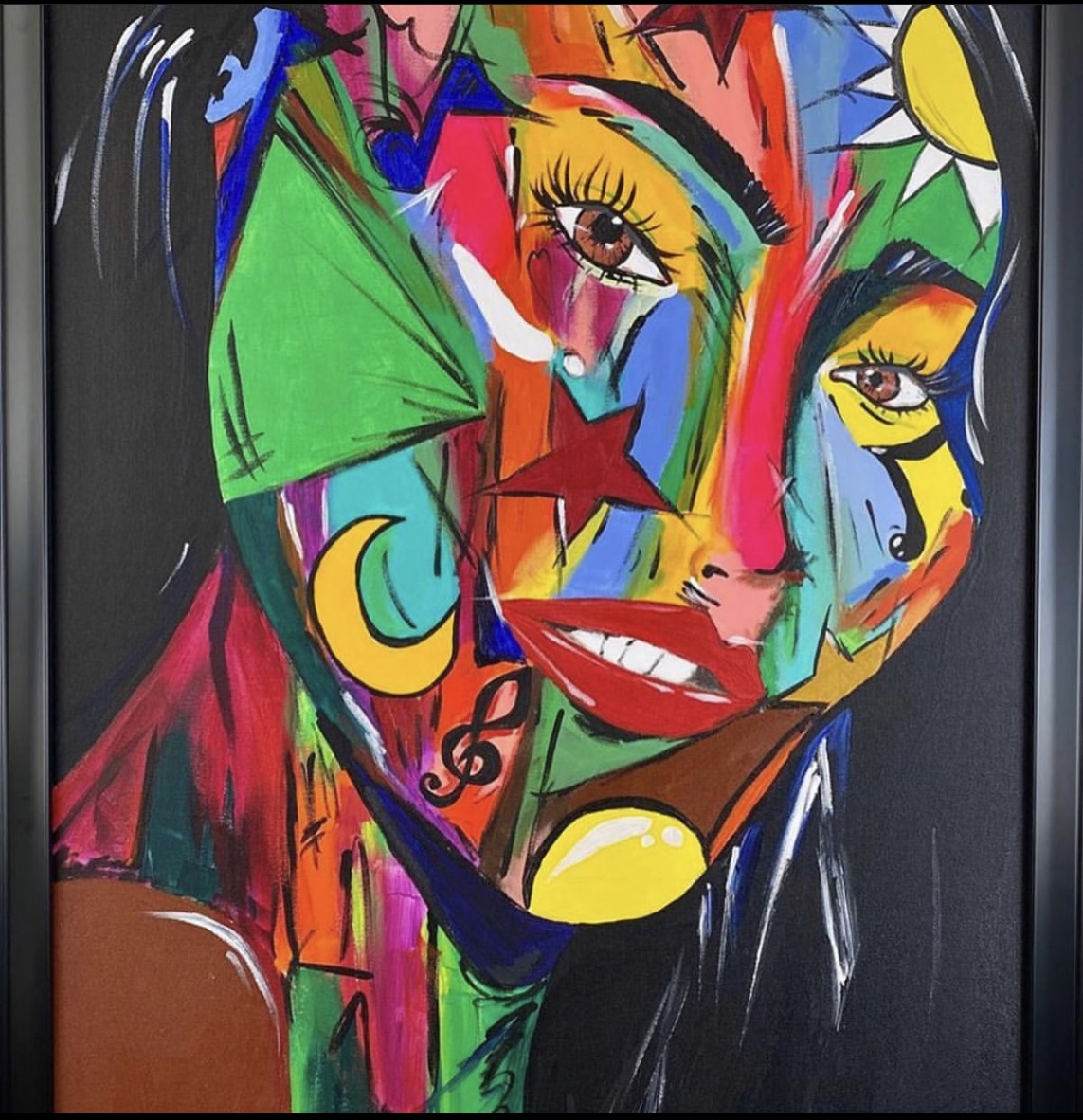 Colorful abstract portrait of a smiling woman with various shapes and bright colors, including stars, moons, and geometric patterns.