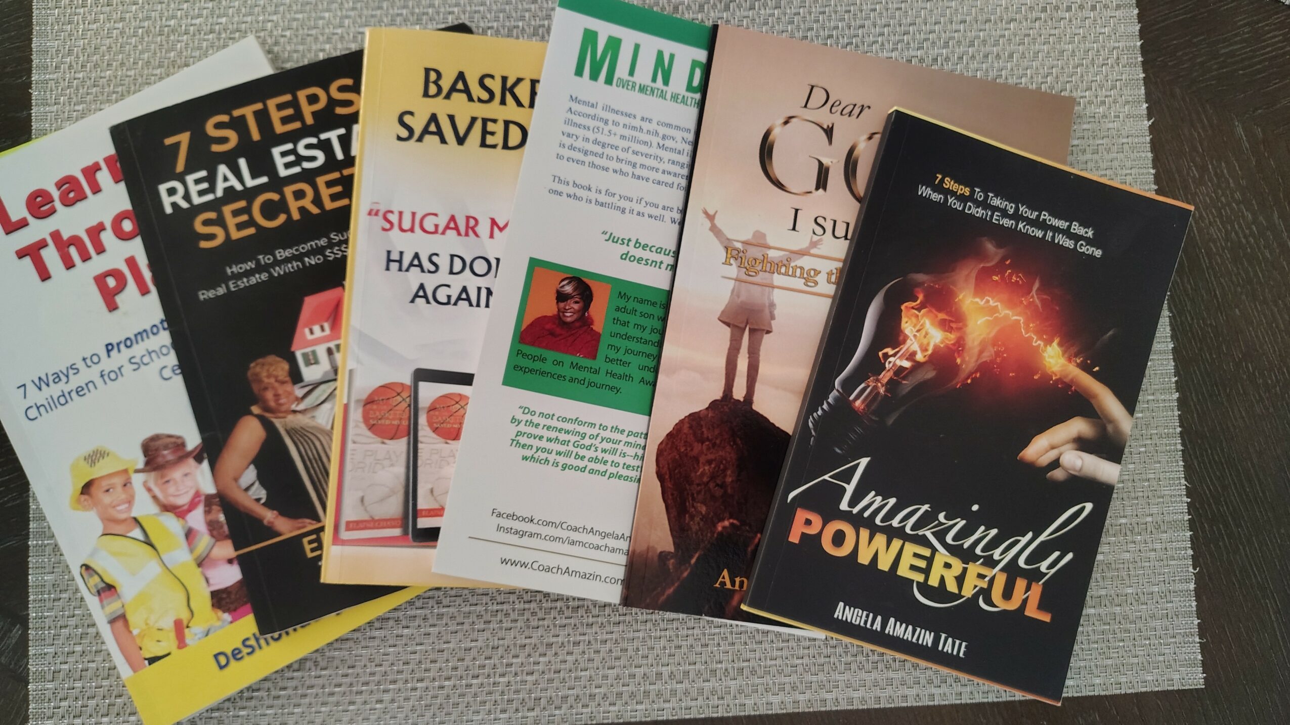 Six books fanned out on a surface, with titles partially visible, including '7 Steps to Real Estate Secrets' and 'Amarillo Powerful'.