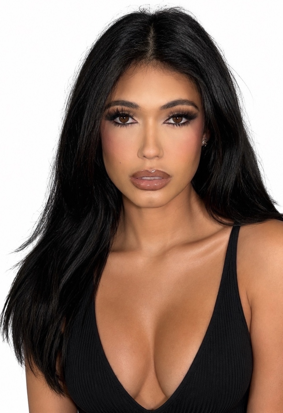 Portrait of a woman with long black hair, wearing a black top, looking directly at the camera.