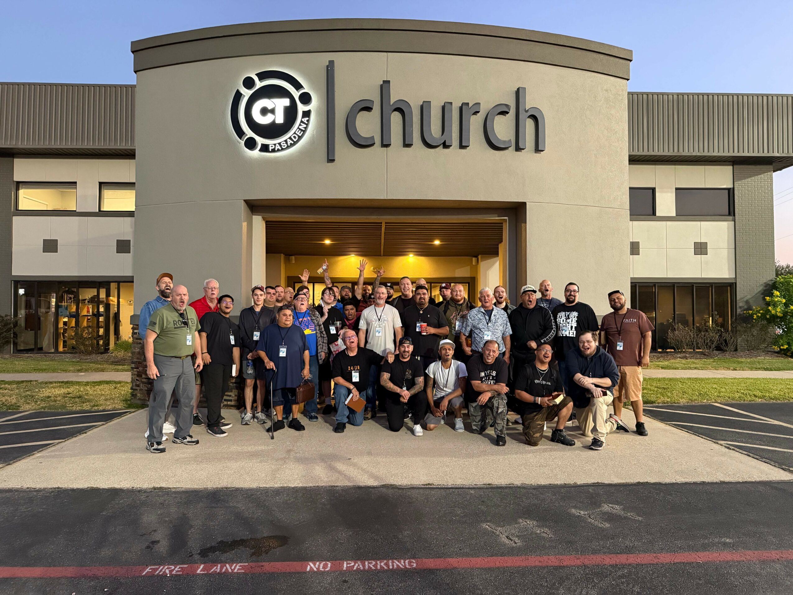 Group of people standing outside a building with a sign that reads 'Cultch'.