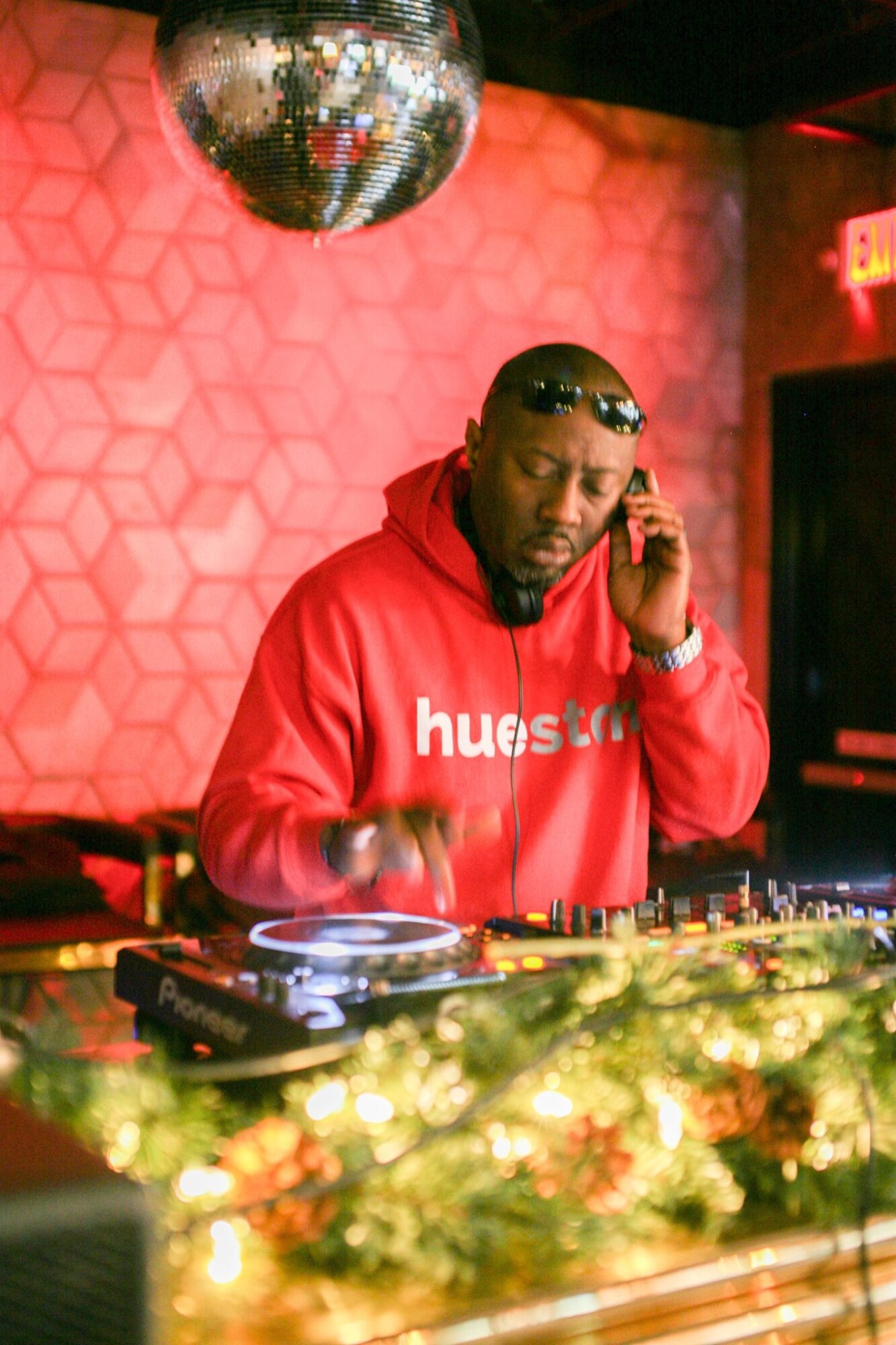 DJ wearing a red hoodie with