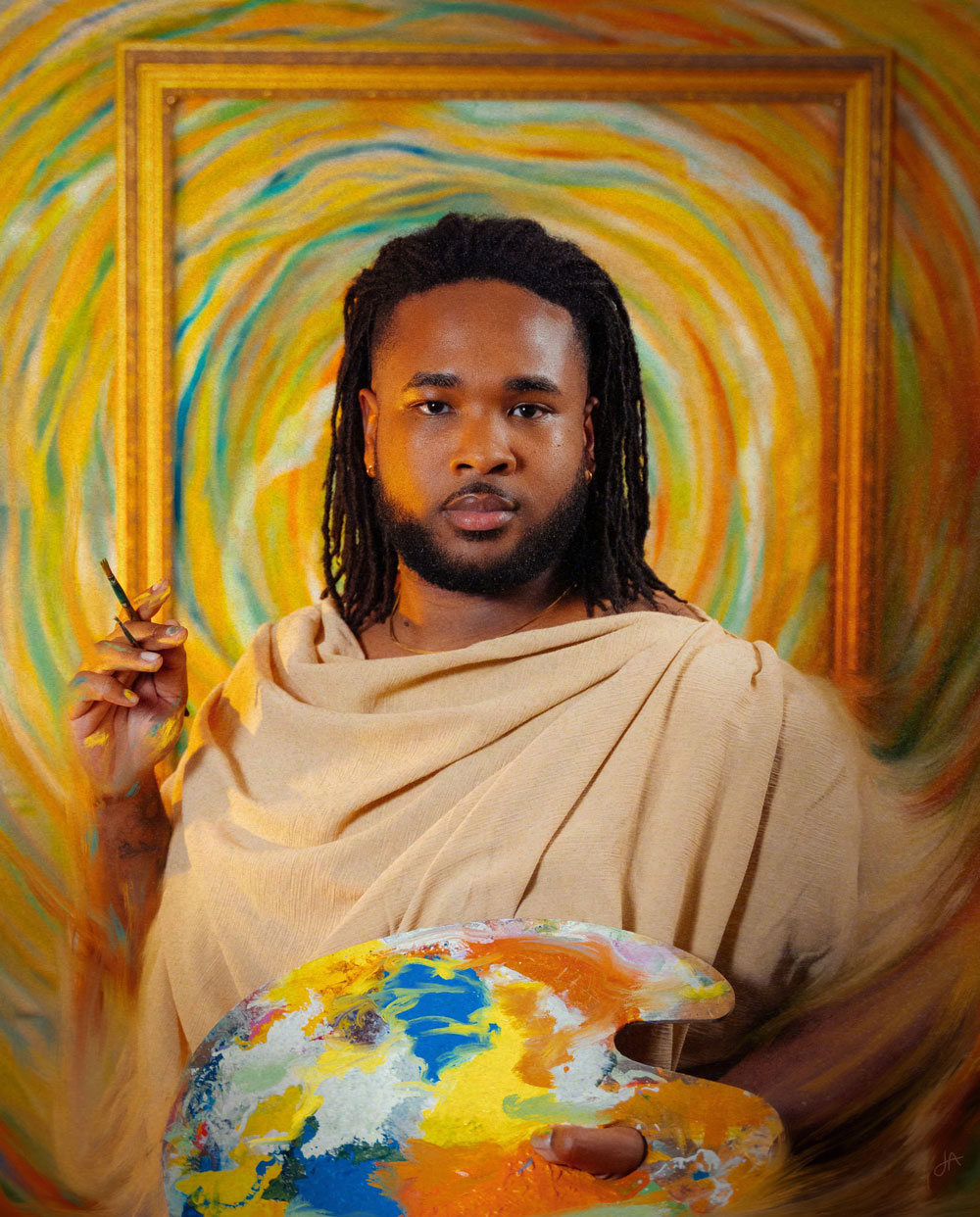 Person with dreadlocks wearing a beige garment, holding a paintbrush, standing in front of a colorful abstract background.